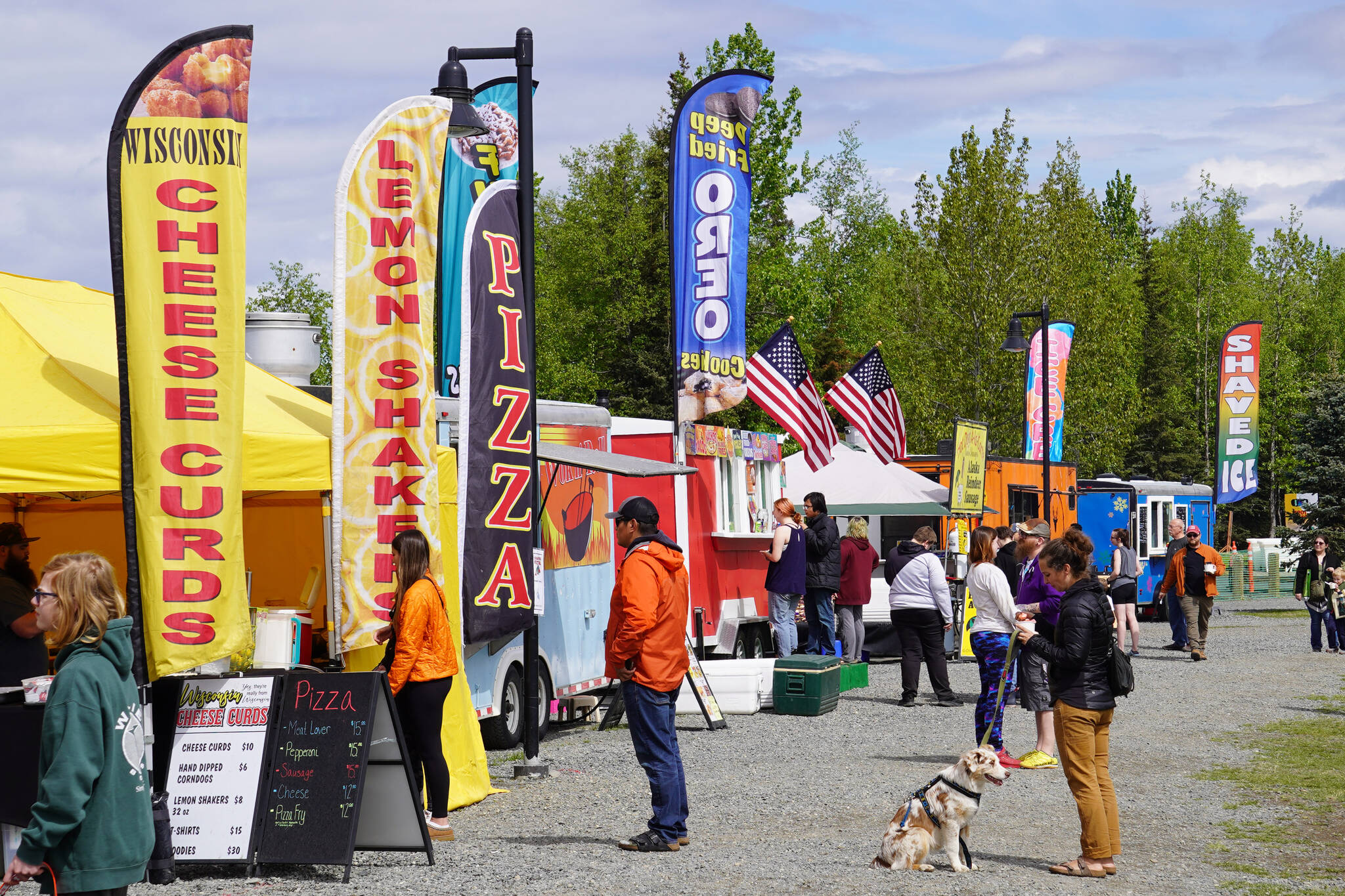 Rows of food trucks and other vendors serve lines of attendees during the Kenai River Festival on Friday, June 9, 2023, at Soldotna Creek Park in Soldotna, Alaska. (Jake Dye/Peninsula Clarion)