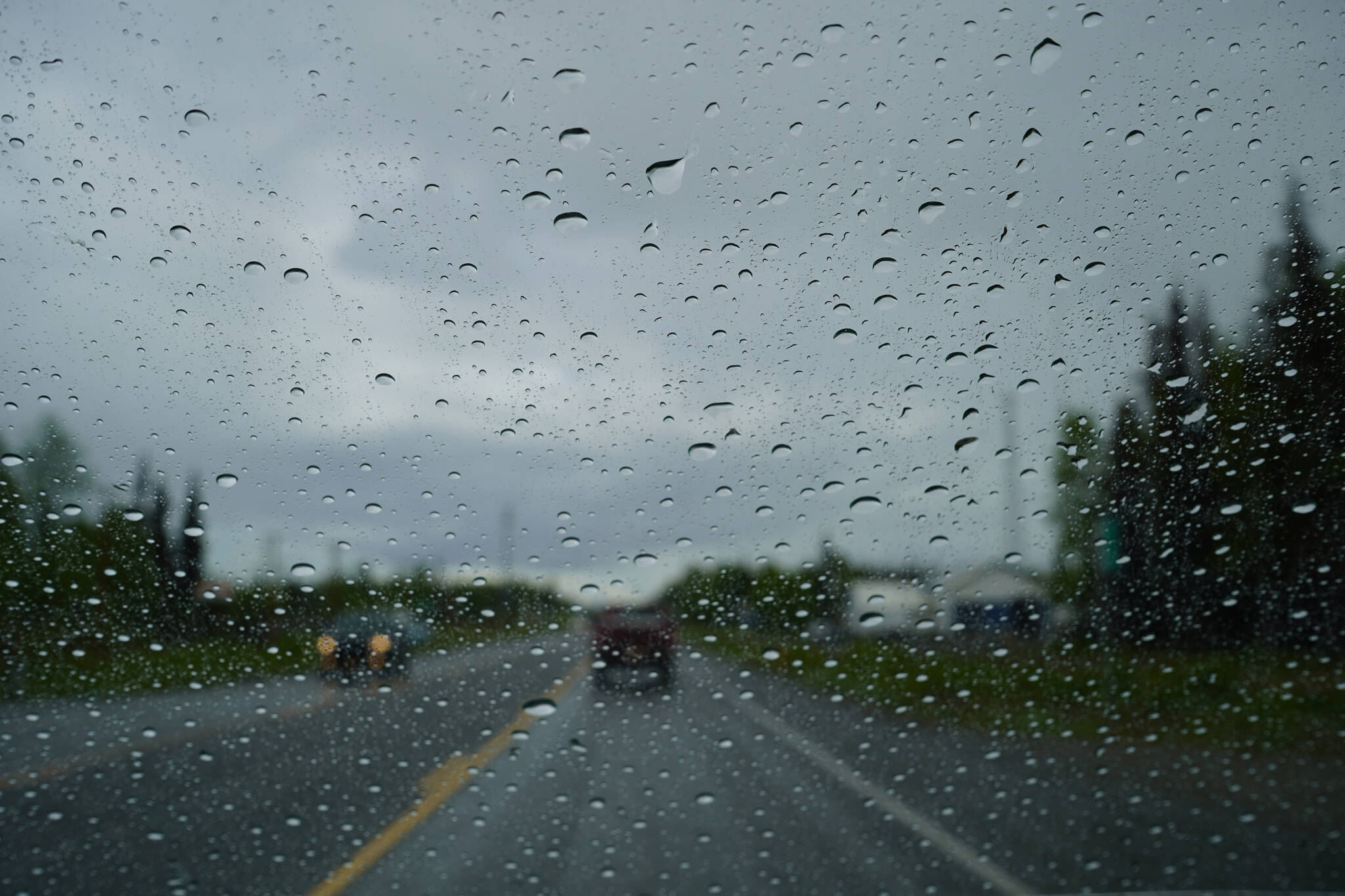 Rainfall covers a windshield on Kalifornsky Beach Road in Soldotna, Alaska, on Friday, June 9, 2023. (Jake Dye/Peninsula Clarion)