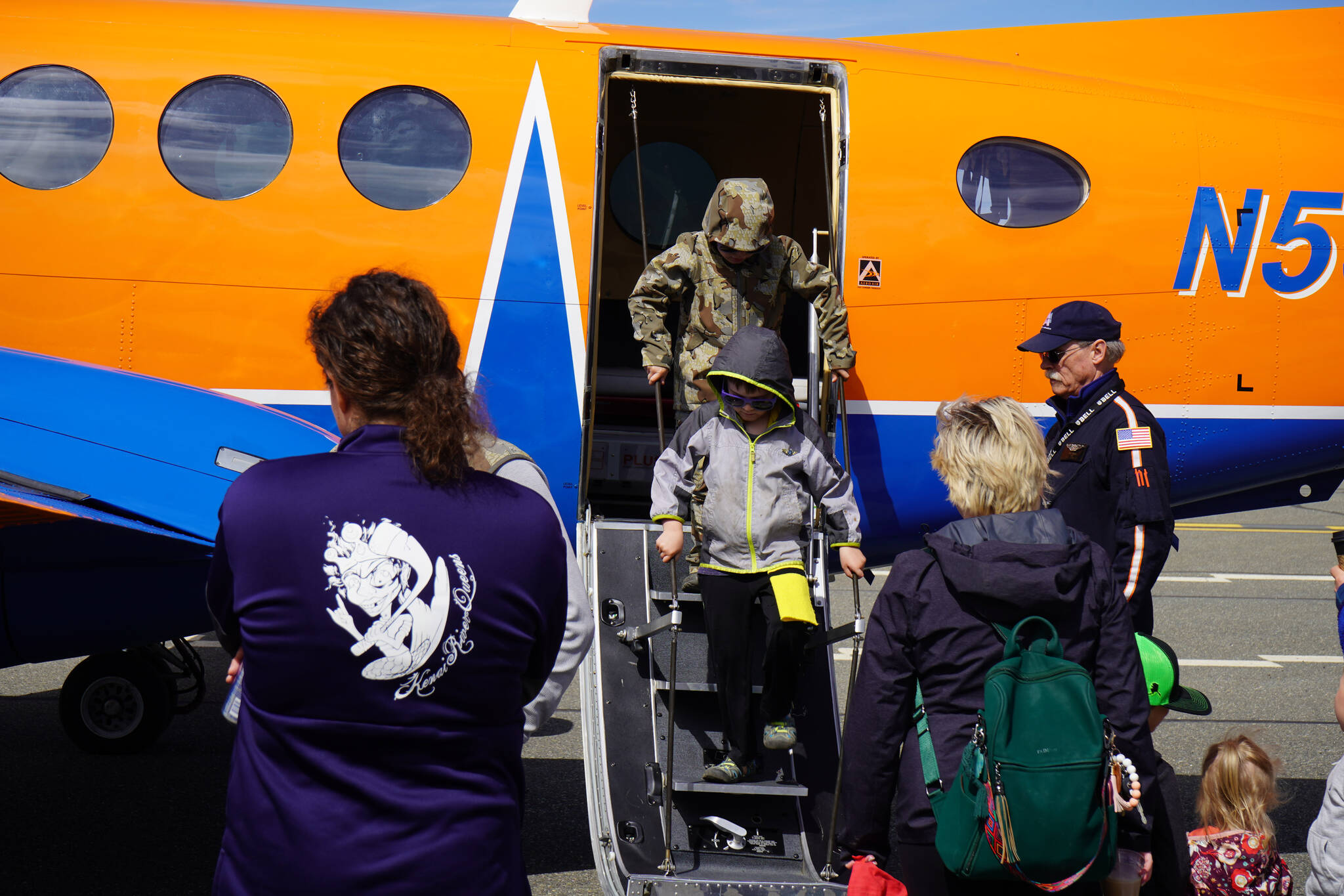 Attendees tour a plane displayed at the Kenai Peninsula Air Fair on Saturday, June 10, 2023, at the Kenai Municipal Airport in Kenai, Alaska. (Jake Dye/Peninsula Clarion)