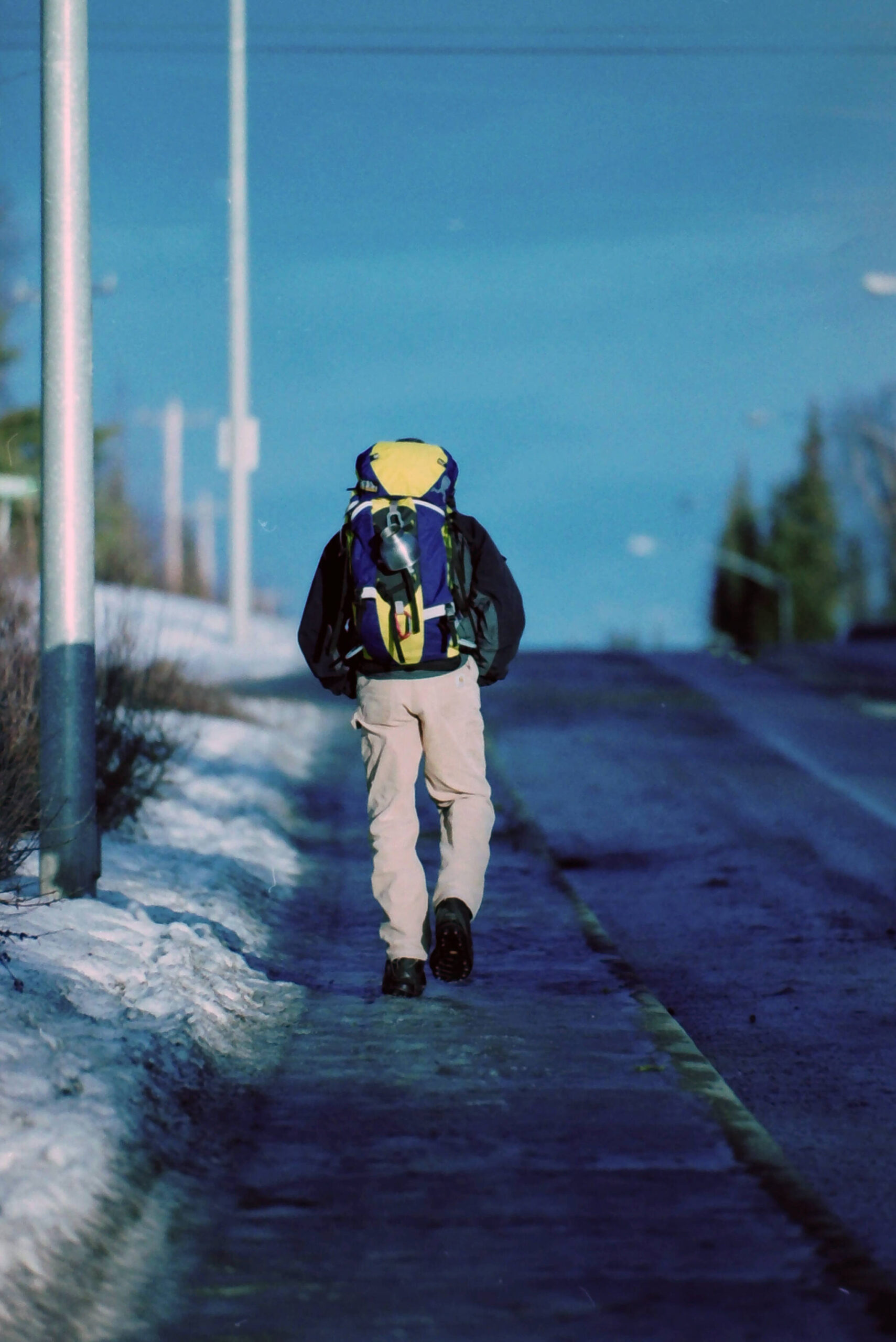 Robert Summer, wearing a 25-pound backpack, makes his way along Kobuk Street in Soldotna, Alaska, in November 2004. (M. Scott Moon/Peninsula Clarion file)