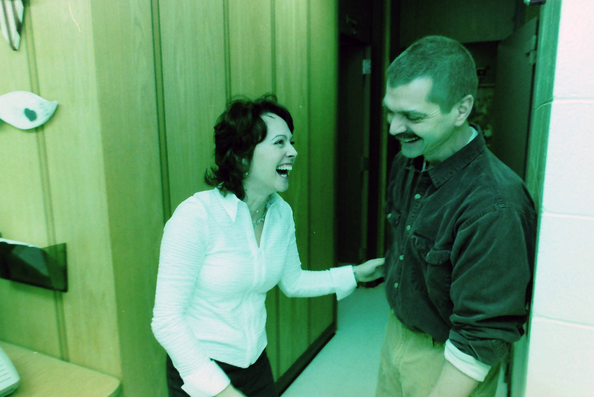 Robert Summer laughs in the office with Carole Nolden at Kenai Middle School in Kenai, Alaska, in November 2004. (M. Scott Moon/Peninsula Clarion)