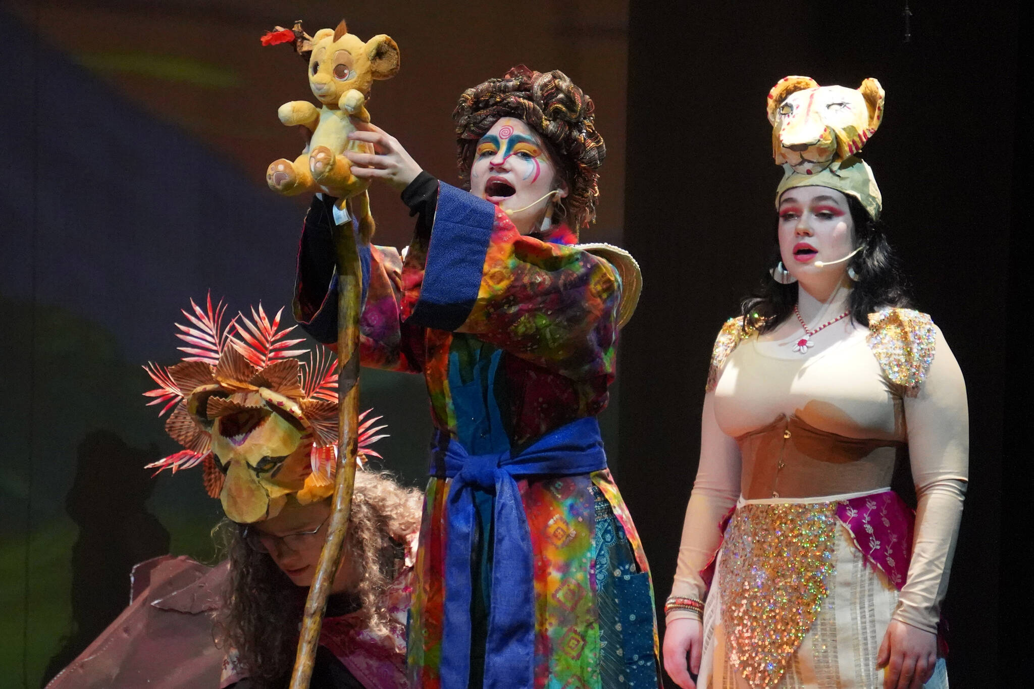 Gavin Hunt portrays Mufasa, Oshie Broussard portrays Rafiki and Charli Byrd portrays Sarabi during a rehearsal of “The Lion King Jr.” in the Renee C. Henderson Auditorium in Kenai, Alaska, on Tuesday, June 6, 2023. (Jake Dye/Peninsula Clarion)