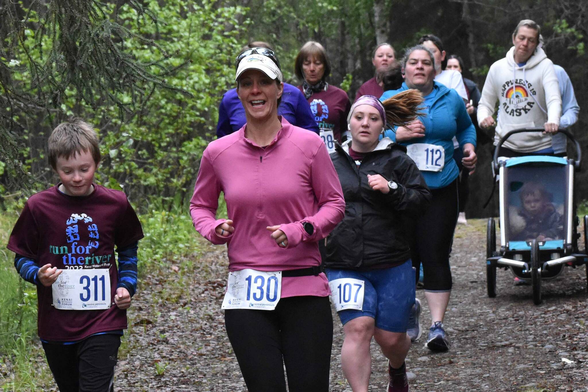 Conner Morris and Kylie Morris lead a pack of runners at the Run for the River on Saturday, June 10, 2023, in Soldotna, Alaska. (Photo by Jeff Helminiak/Peninsula Clarion)
