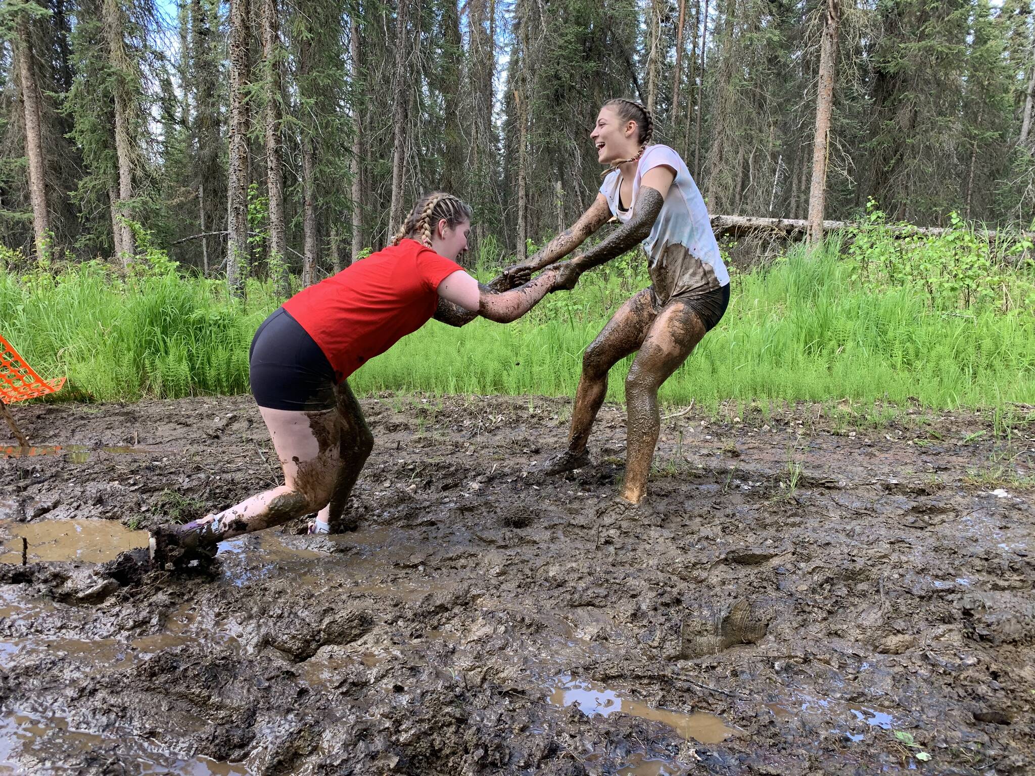 Muddy runners move down the Tsalteshi Trails’ Porcupine Loop in Soldotna, Alaska, as they participate in the KDLL Mud Run on Friday, June 16, 2023. (Photo provided by KDLL 91.9 FM)