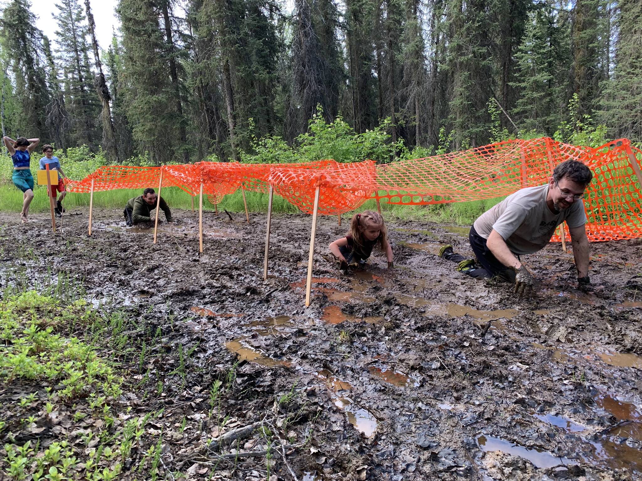 Muddy runners move down the Tsalteshi Trails’ Porcupine Loop in Soldotna, Alaska, as they participate in the KDLL Mud Run on Friday, June 16, 2023. (Photo provided by KDLL 91.9 FM)