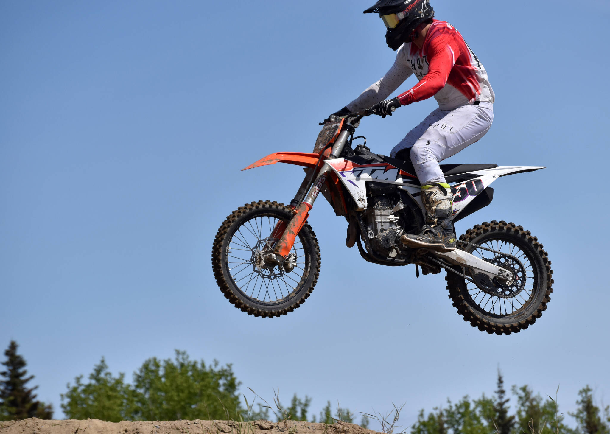 A racer flies through the air at the Alaska State Motocross Race 3 on Saturday, June 17, 2023, at Twin City Raceway in Kenai, Alaska. (Photo by Jeff Helminiak/Peninsula Clarion)