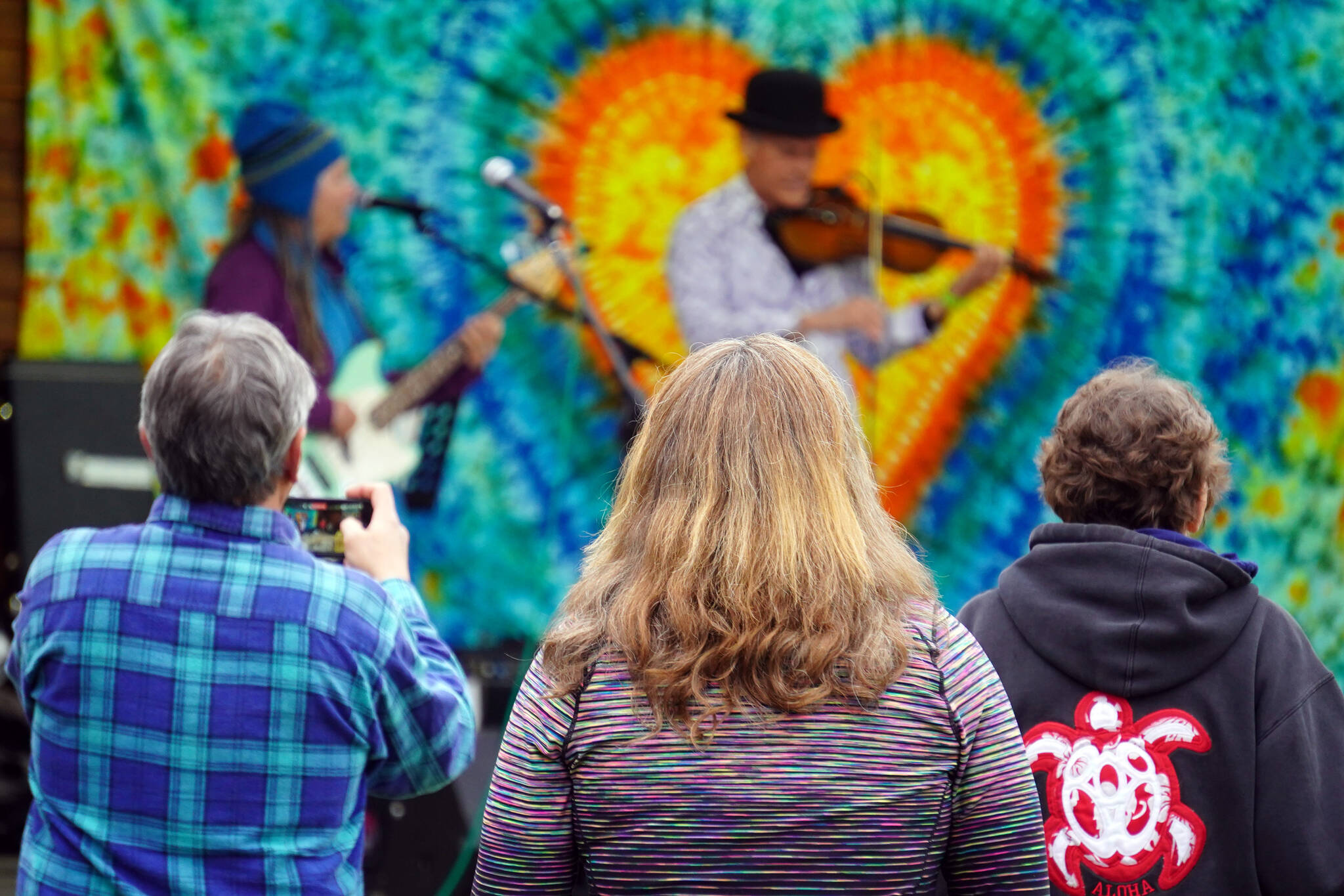Attendees gather before the stage as Connie Brannock’s Tiny House of Funk performs during the Soldotna Music Series at Soldotna Creek Park in Soldotna, Alaska, on Wednesday, June 21, 2023. (Jake Dye/Peninsula Clarion)