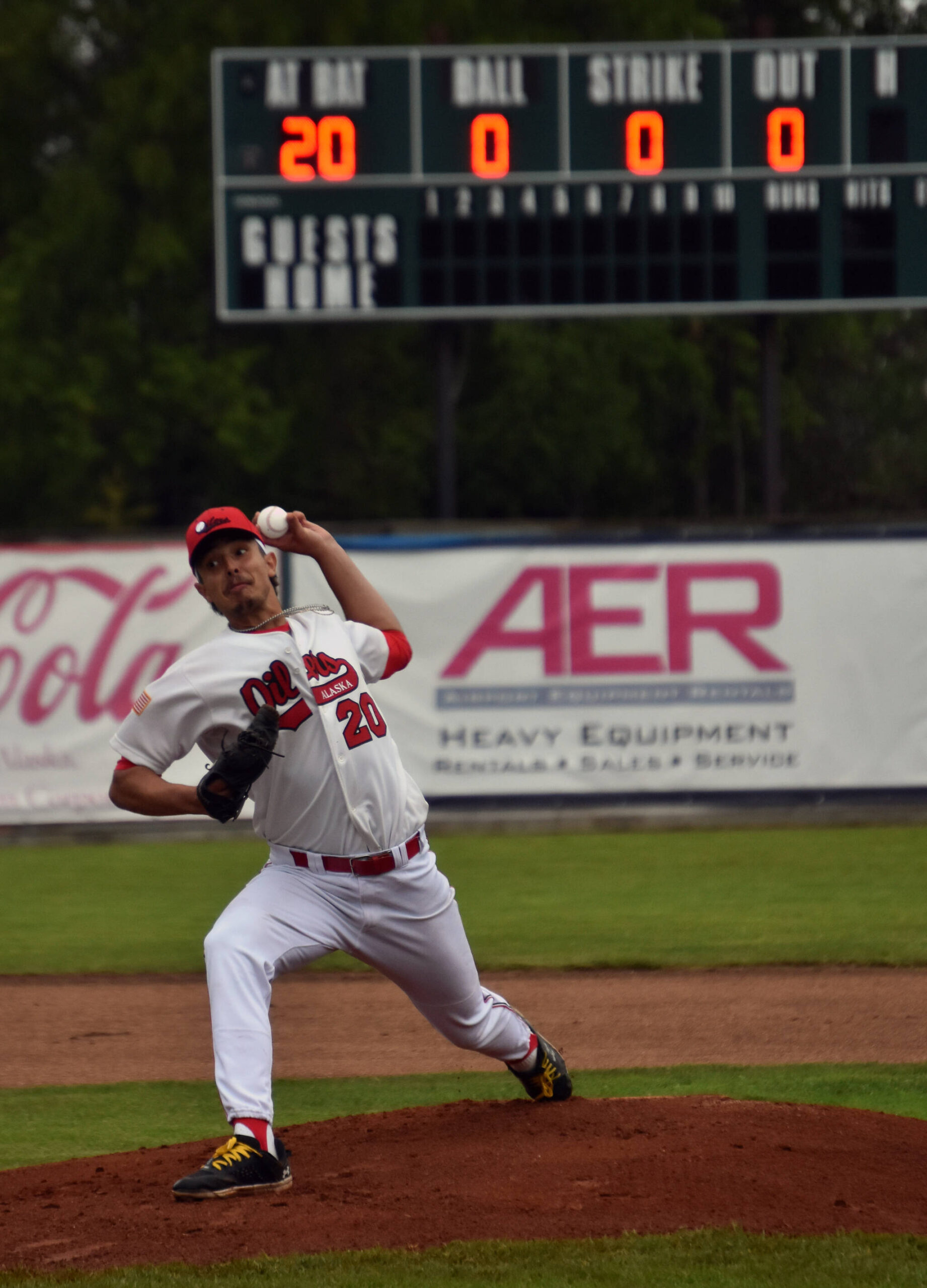 Peninsula OIlers starter Arnad Mulamekic delivers the first pitch of the Oilers home schedule at Coral Seymour Memorial Park in Kenai, Alaska, on Wednesday, June 21, 2023. (Photo by Jeff Helminiak/Peninsula Clarion)