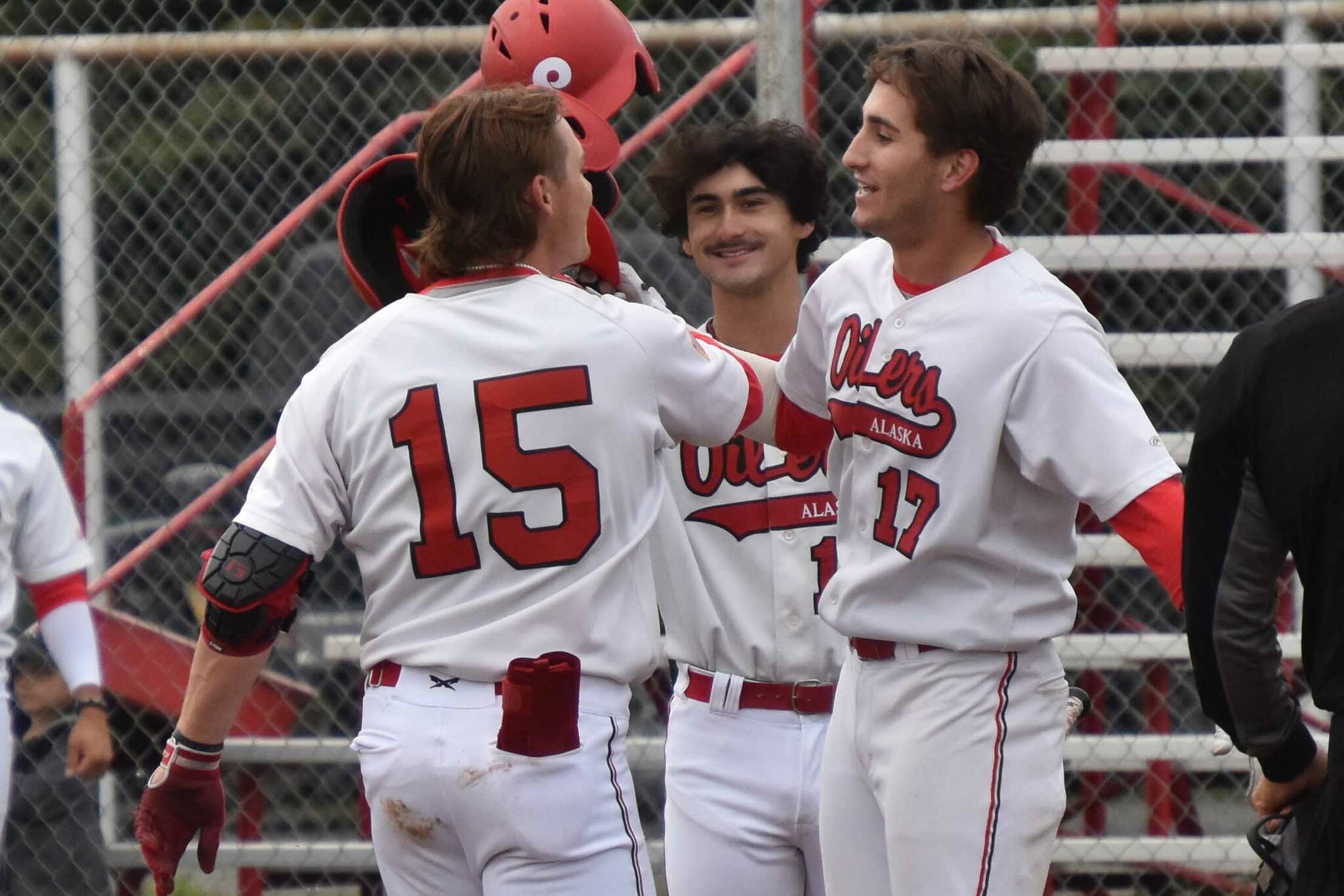 Peninsula Oilers catcher Ben Griffin celebrates his first inning homer with Theo Forshey on Wednesday, June 22, 2023, at Coral Seymour Memorial Park in Kenai, Alaska. (Photo by Jeff Helminiak/Peninsula Clarion)