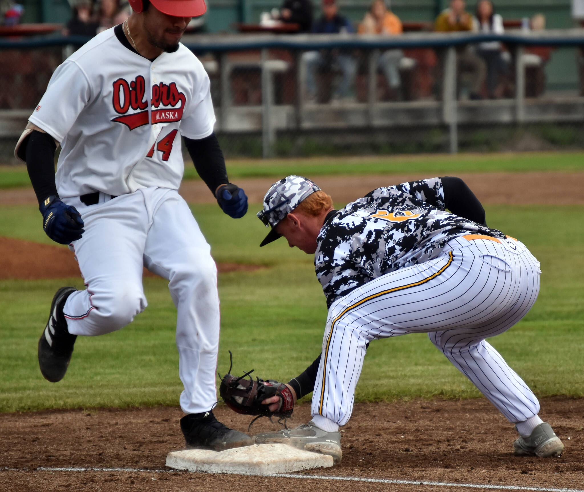 Peninsula Oilers’ Josiah Chavez is out at first after a sacrfice bunt as Anchorage Bucs second baseman Alex Pendergast makes the catch Friday, June 23, 2023, at Coral Seymour Memorial Park in Kenai, Alaska. (Photo by Jeff Helminiak/Peninsula Clarion)