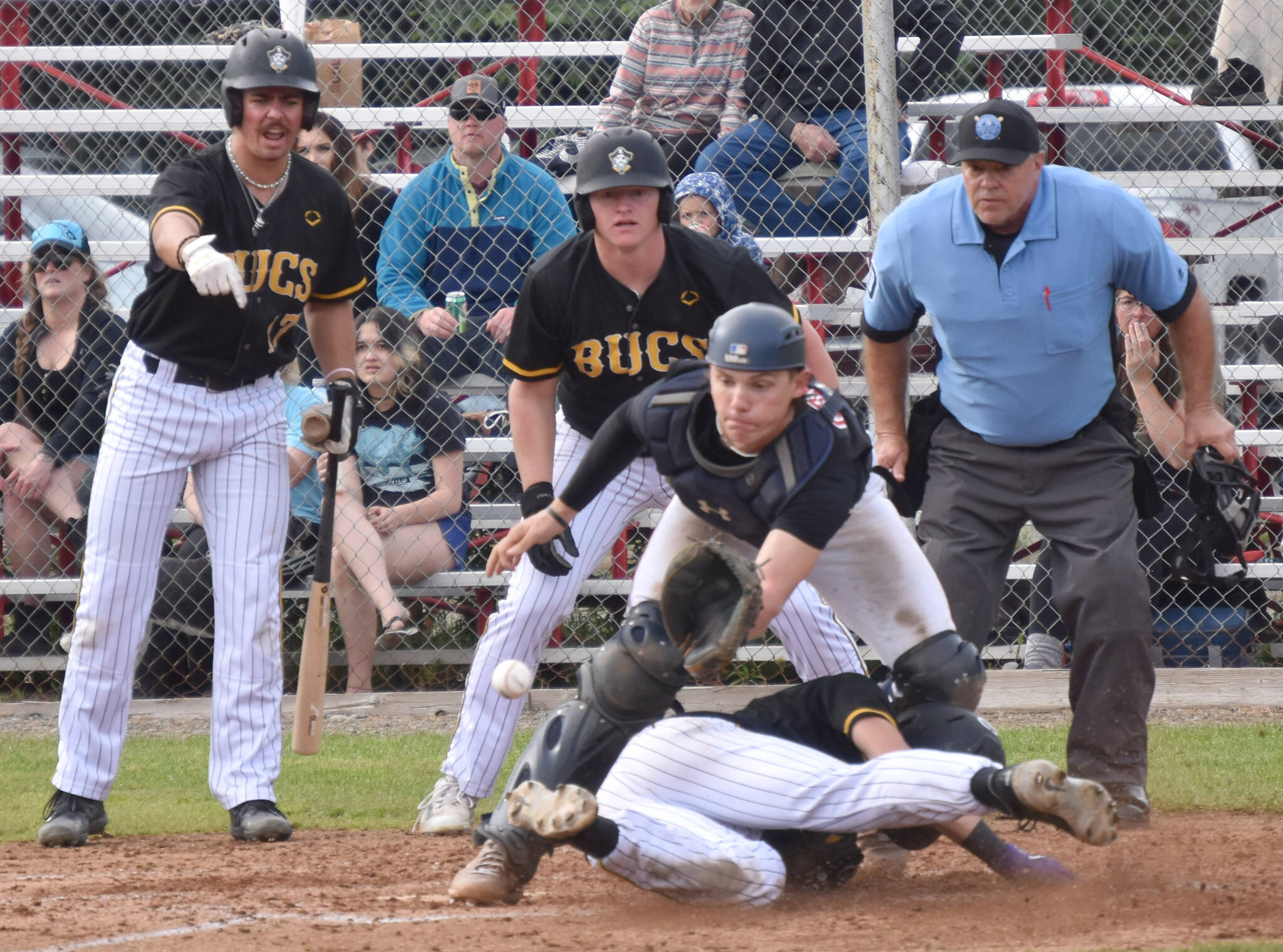 Anchorages Bucs’ Curtis Hebert beats the tag of Peninsula Oilers catcher Ben Griffin on Saturday, June 24, 2023, at Coral Seymour Memorial Park in Kenai, Alaska. (Photo by Jeff Helminiak/Peninsula Clarion)