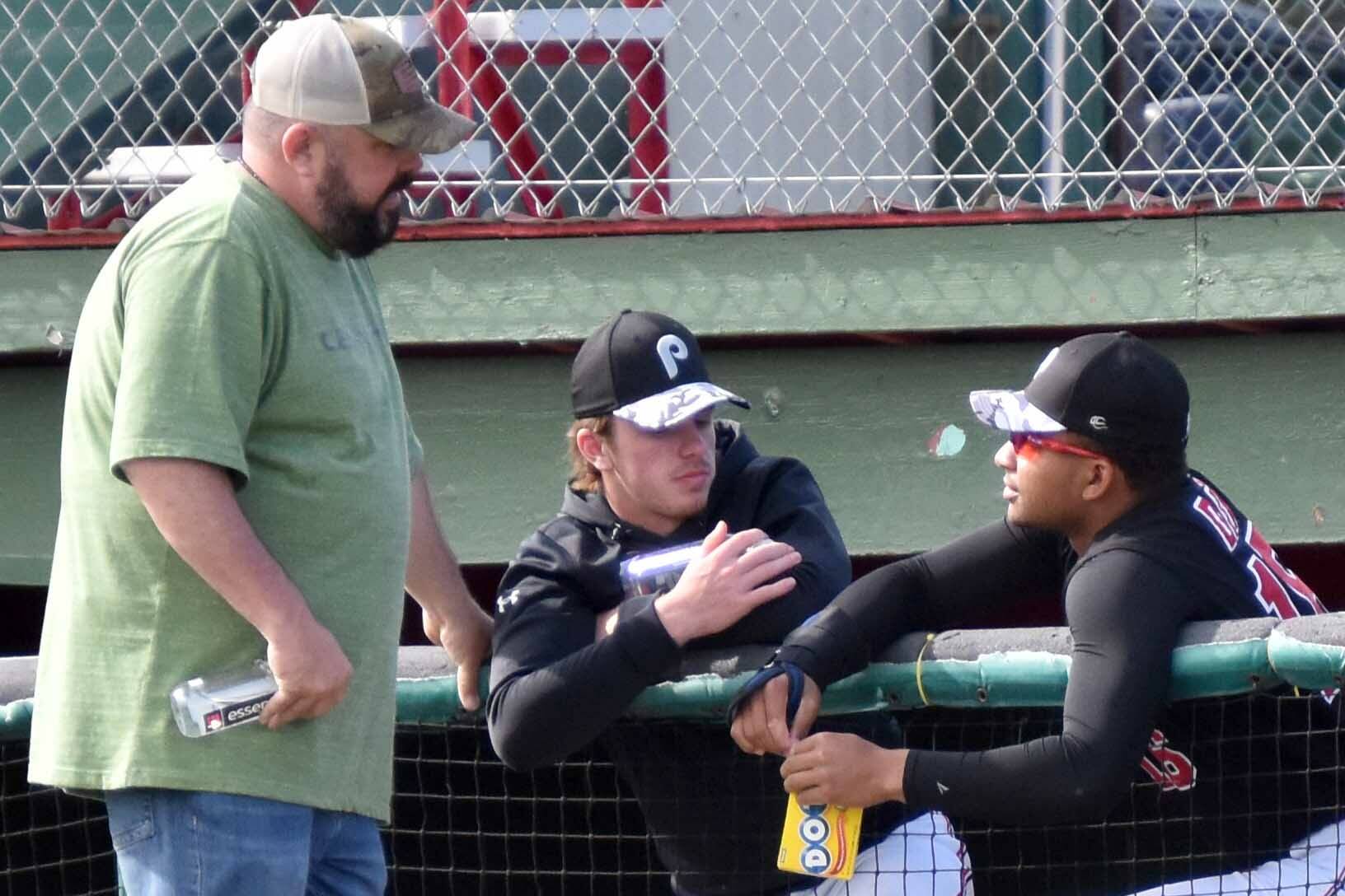 Oilers general manager Derek Foote talks with a pair of players Saturday, June 24, 2023, before a game against the Anchorage Bucs at Coral Seymour Memorial Park in Kenai, Alaska. (Photo by Jeff Helminiak/Peninsula Clarion)