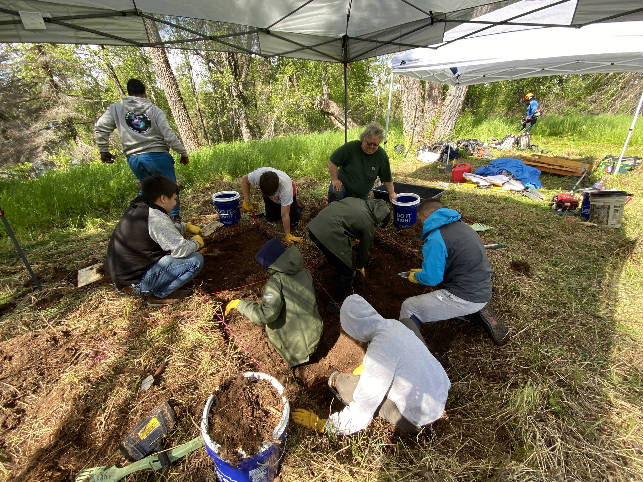 The interns working with Salamatof Tribe Duhdeldiht Youth Services excavate an archaeological site near Nikiski, Alaska. (Photo courtesy Michael Bernard)