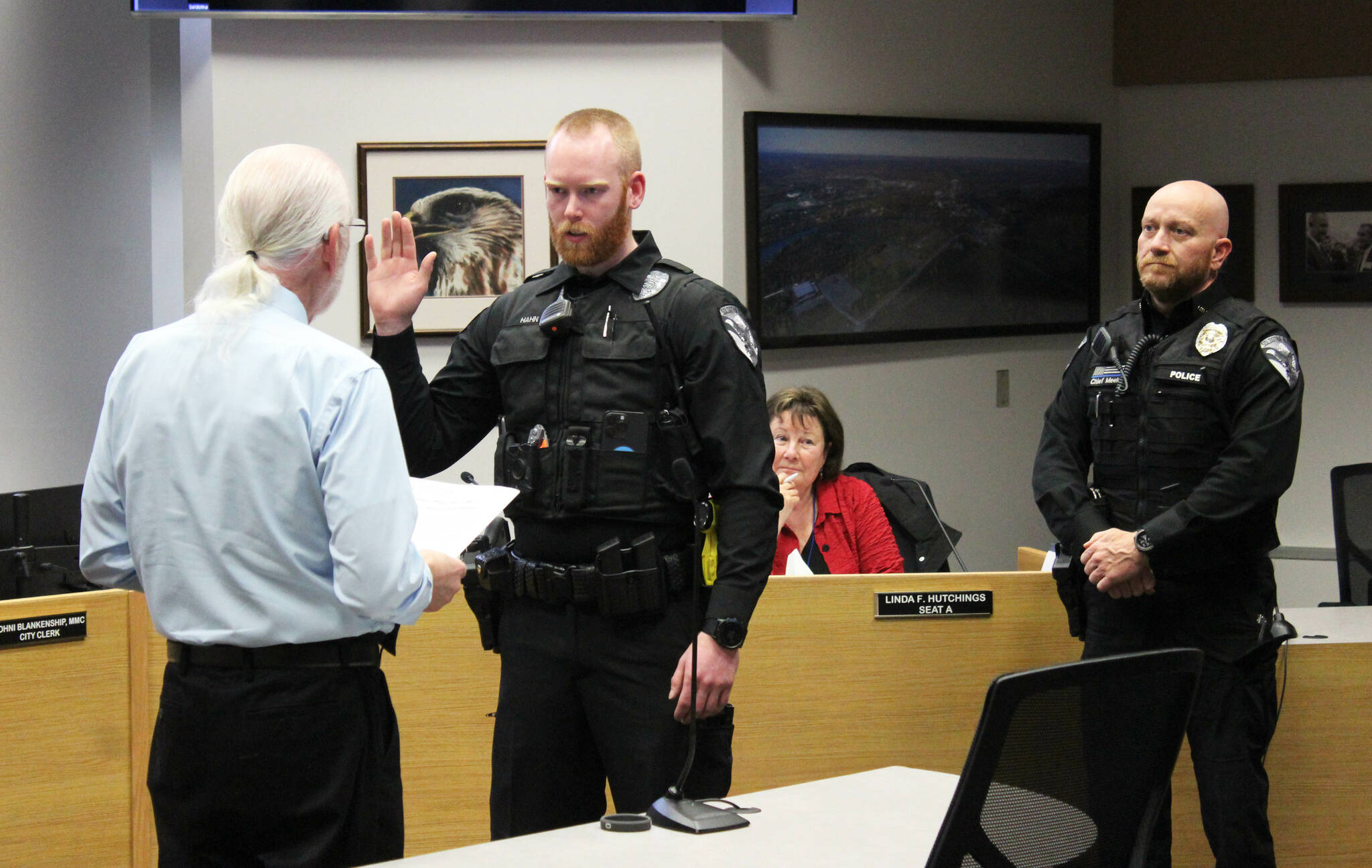 From left, Soldotna Mayor Paul Whitney swears in Soldotna Police Officer Bryan Hahn while Soldotna Police Chief Gene Meek looks on during a Soldotna City Council meeting on Wednesday, June 28, 2023 in Soldotna, Alaska. (Ashlyn O'Hara/Peninsula Clarion)