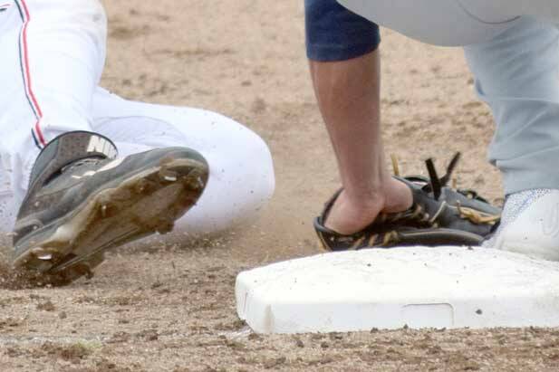 Oilers' Caleb Hicks is tagged out by Glacier Pilots third baseman Sam Fragale in the first inning Thursday at Coral Seymour Memorial Park in Kenai. (Photo by Jeff Helminiak/Peninsula Clarion)