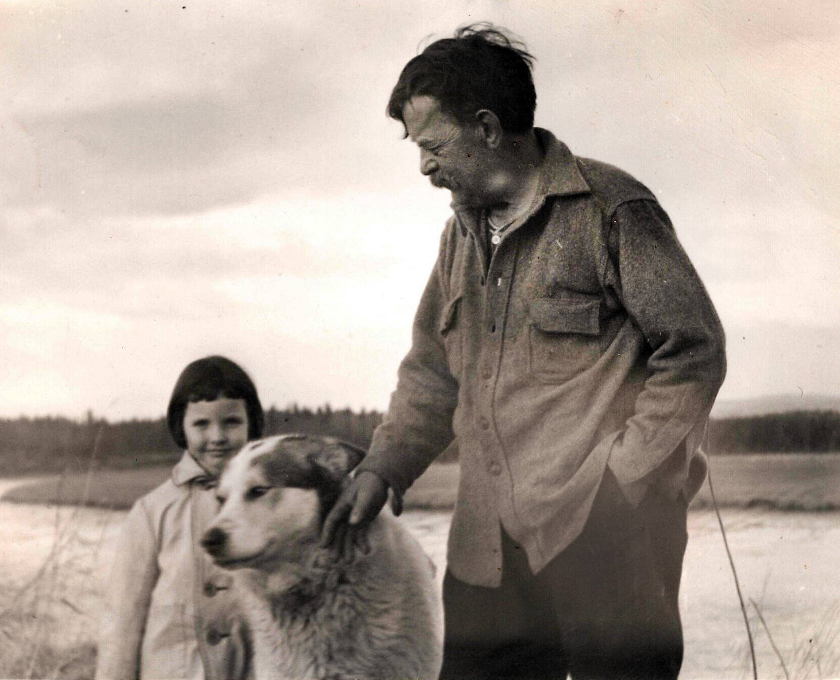 In this Knackstedt Collection photo, probably from circa the 1940s, Windy Wagner enjoys the company of young Lori Lancashire and a friendly dog.
