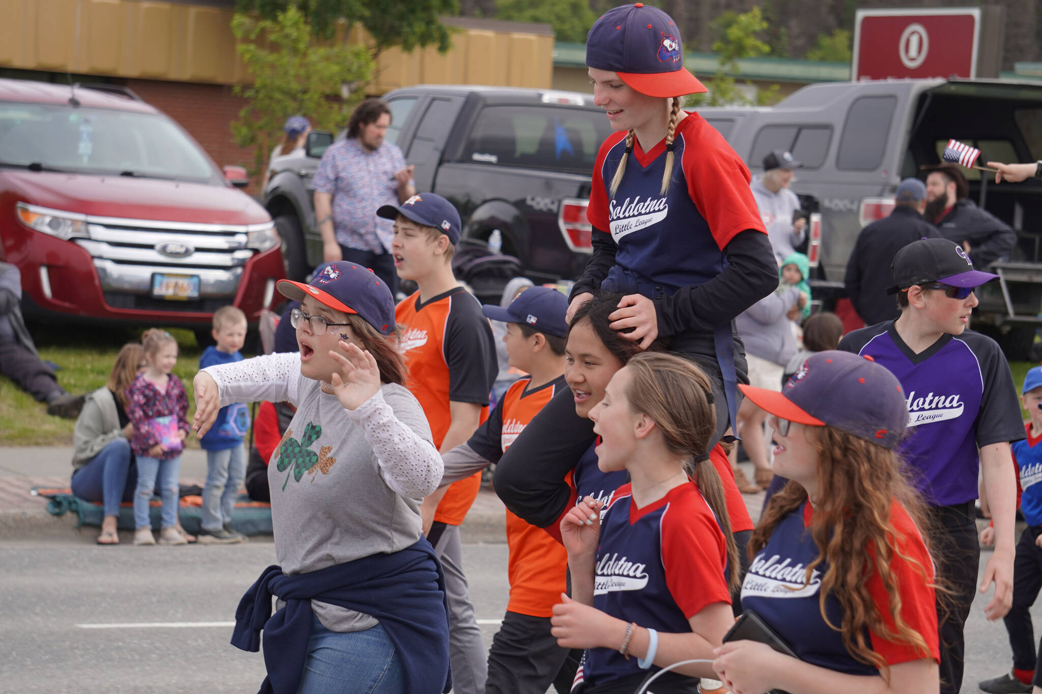 Soldotna Little League players call out to attendees as the Fourth of July Parade moves down the Kenai Spur Highway in Kenai, Alaska on Tuesday, July 4, 2023. (Jake Dye/Peninsula Clarion)