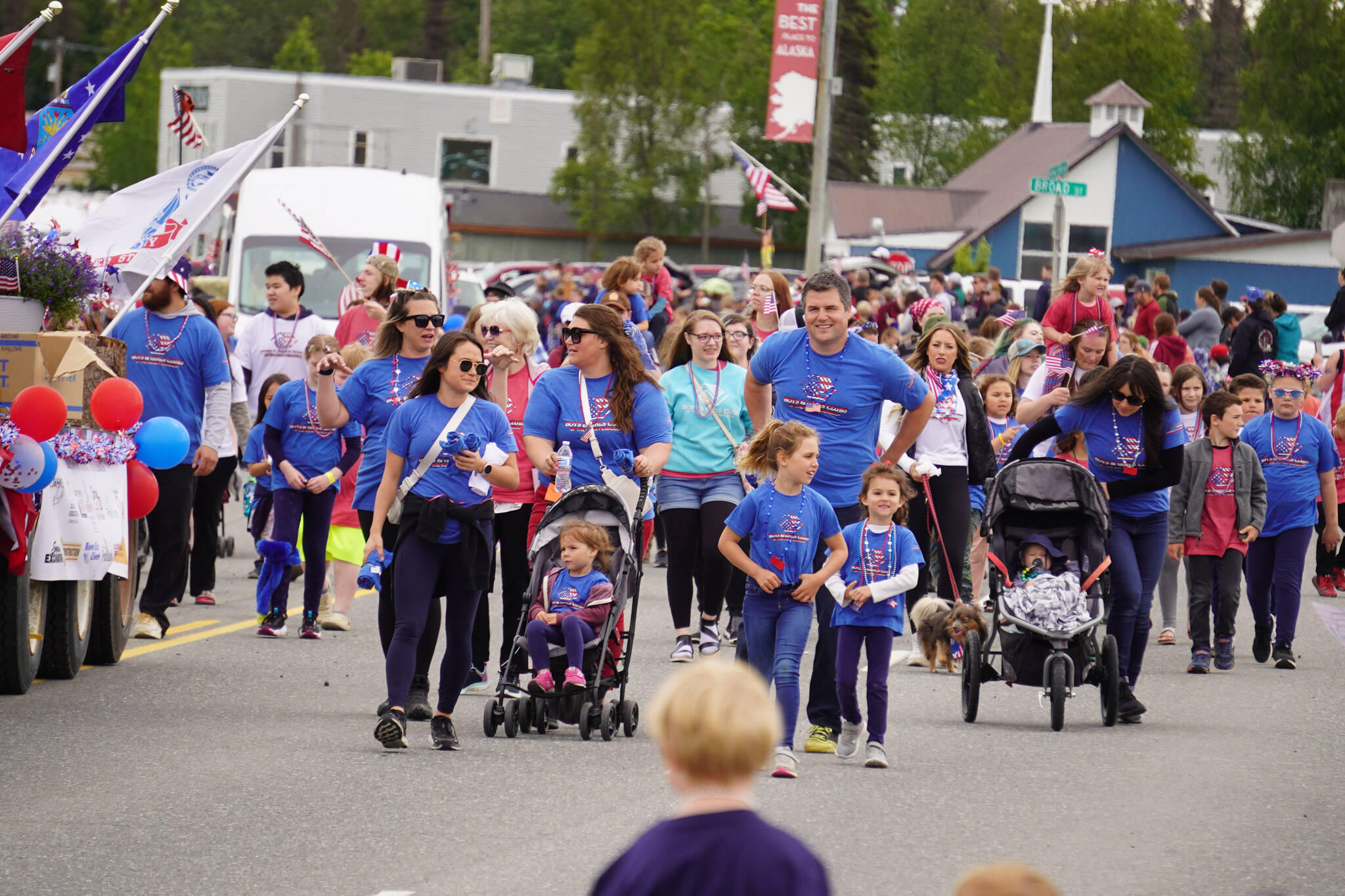 The Boys & Girls Clubs of the Kenai Peninsula smile and wave as the Fourth of July Parade moves down the Kenai Spur Highway in Kenai, Alaska on Tuesday, July 4, 2023. (Jake Dye/Peninsula Clarion)