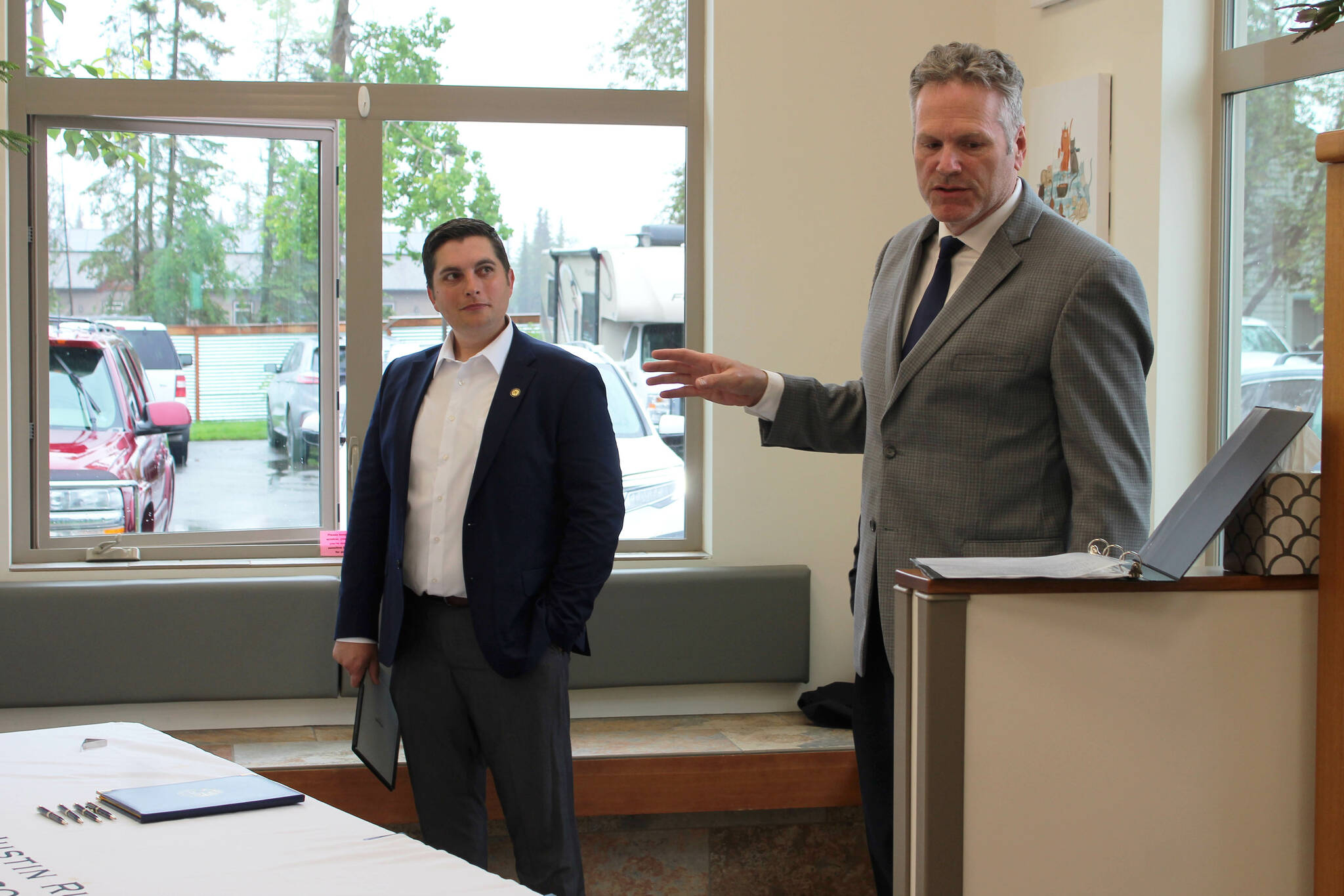 Gov. Mike Dunleavy (right) delivers opening remarks at a bill signing event at Twin Cities Veterinary Clinic on Thursday, July 6, 2023 in Soldotna, Alaska. (Ashlyn O’Hara/Peninsula Clarion)