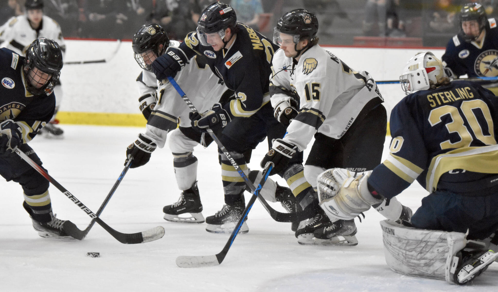 Janesville (Wisconsin) Jets forward Jaden Johnson, Kenai River Brown Bears forward Bryce Monrean, Janesville forward Parker Mabbett and Kenai River forward Hunter Newhouse battle for the puck in front of Janesville goalie Peter Sterling on Saturday, Feb. 25, 2023, at the Soldotna Regional Sports Complex in Soldotna, Alaska. (Photo by Jeff Helminiak/Peninsula Clarion)