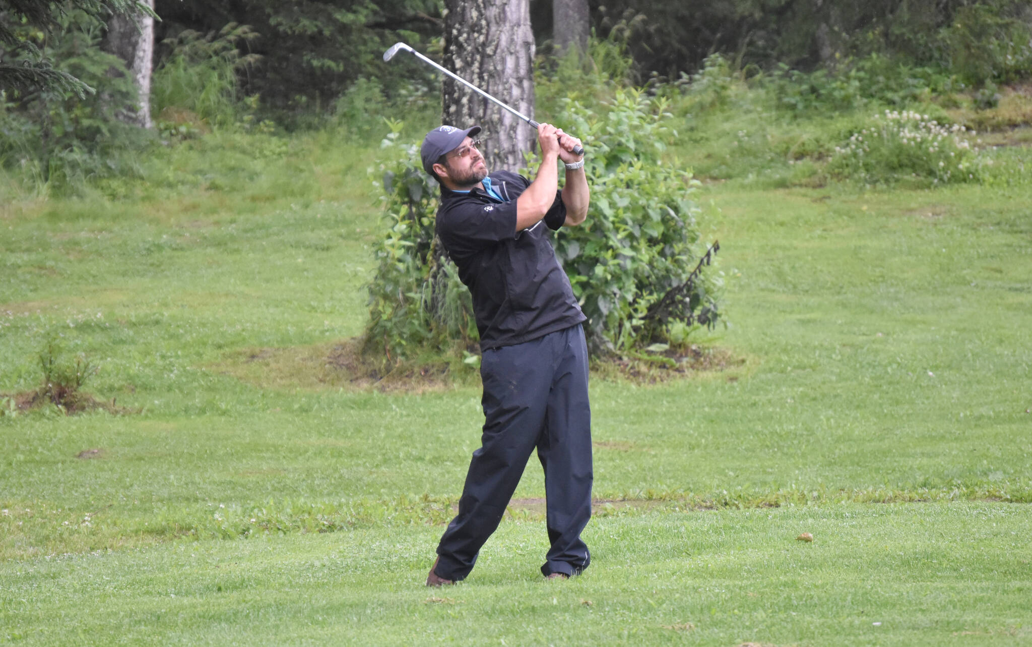 Zac Cowan hits his approach on No. 18 on Sunday, July 16, 2023, at the Kenai Peninsula Open at Birch Ridge Golf Course in Soldotna, Alaska. (Photo by Jeff Helminiak/Peninsula Clarion)