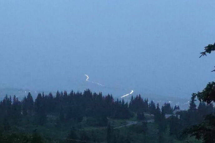 A photo taken from Skyline Drive at about 11:20 p.m. Saturday, July 15, 2023, shows vehicles evacuating from the Homer Spit after a tsunami warning was issued. The warning did not affect the Homer area, but sirens sounded anyway. The warning was later canceled. (Photo by Shannon Cefalu/courtesy)