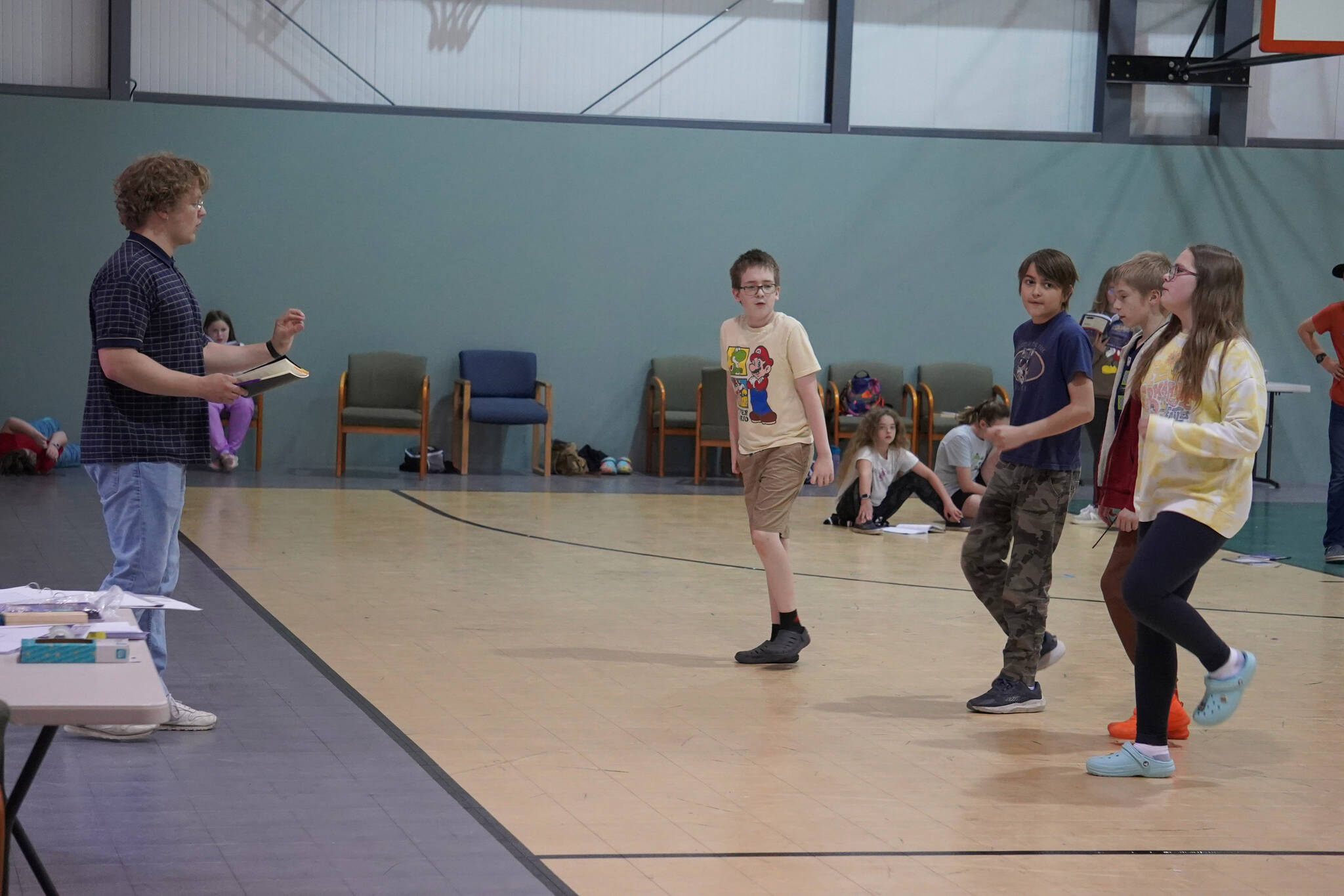 Cooper Kelley directs a rehersal of “The Aristocats Kids” during a Triumvirate Theatre drama camp on Wednesday, July 19, 2023 at the Boys and Girls Club of the Kenai Peninsula Main Office in Kenai, Alaska. (Jake Dye/Peninsula Clarion)