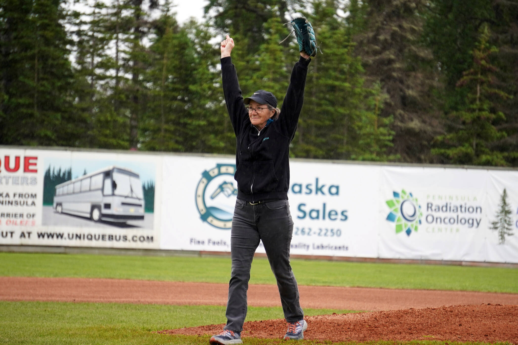 Lisa Parker, vice mayor of Soldotna, celebrates after throwing the ceremonial first pitch before a game between the Peninsula Oilers and the Mat-Su Miners on Tuesday, July 4, 2023, at Coral Seymour Memorial Park in Kenai, Alaska. (Jake Dye/Peninsula Clarion)