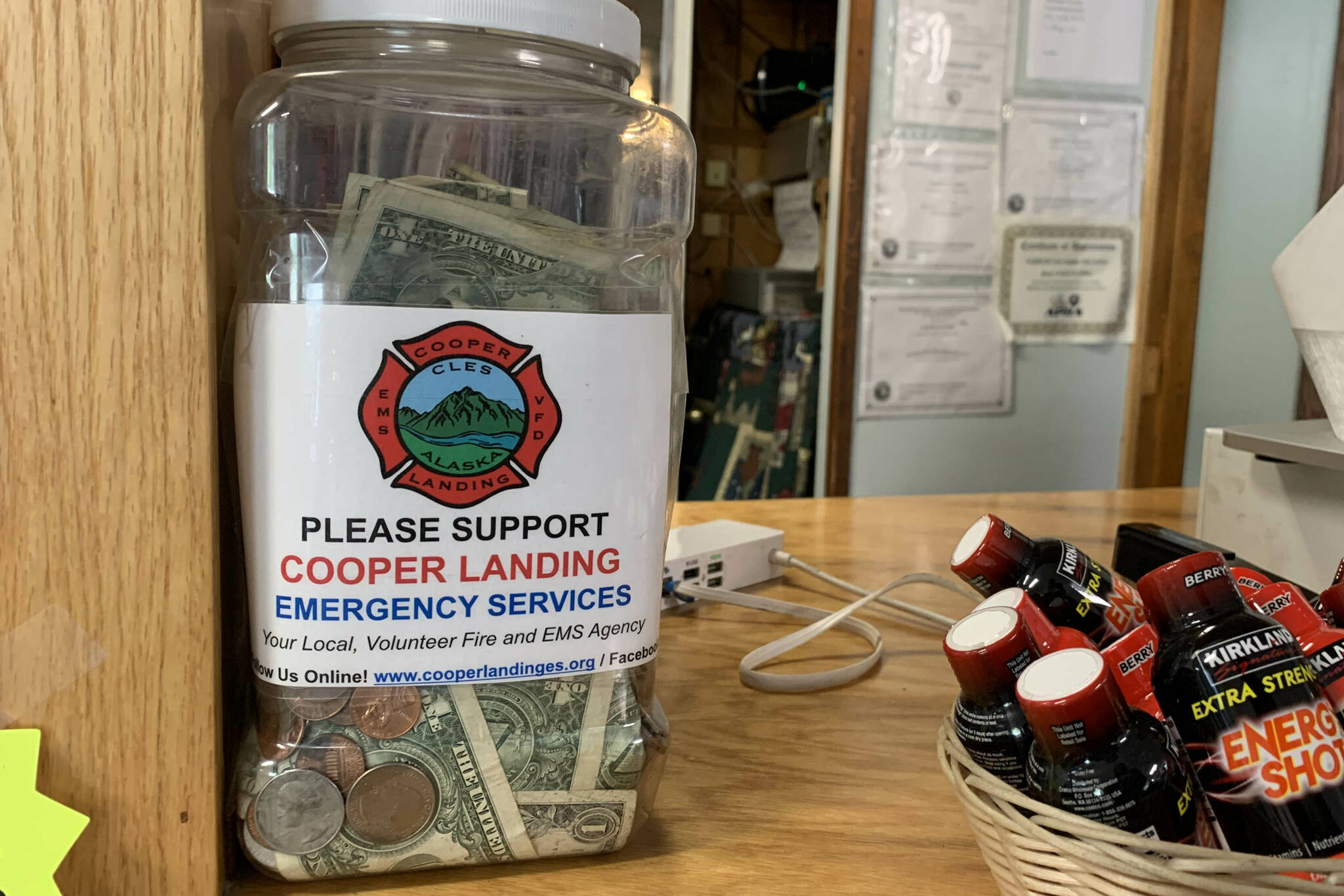 A tip jar collects money for Cooper Landing Emergency Services inside the Sunrise Cafe on Saturday, July 8, 2023, in Cooper Landing, Alaska. (Ashlyn O’Hara/Peninsula Clarion)