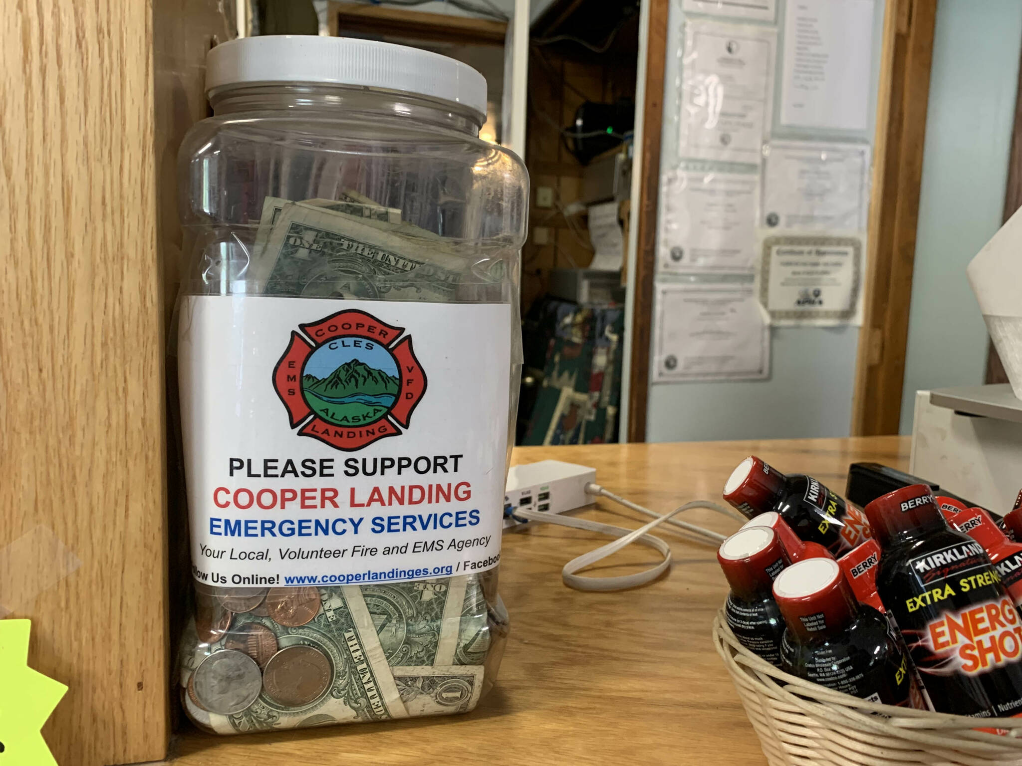 A tip jar collects money for Cooper Landing Emergency Services inside the Sunrise Cafe on Saturday, July 8, 2023, in Cooper Landing, Alaska. (Ashlyn OHara/Peninsula Clarion)
