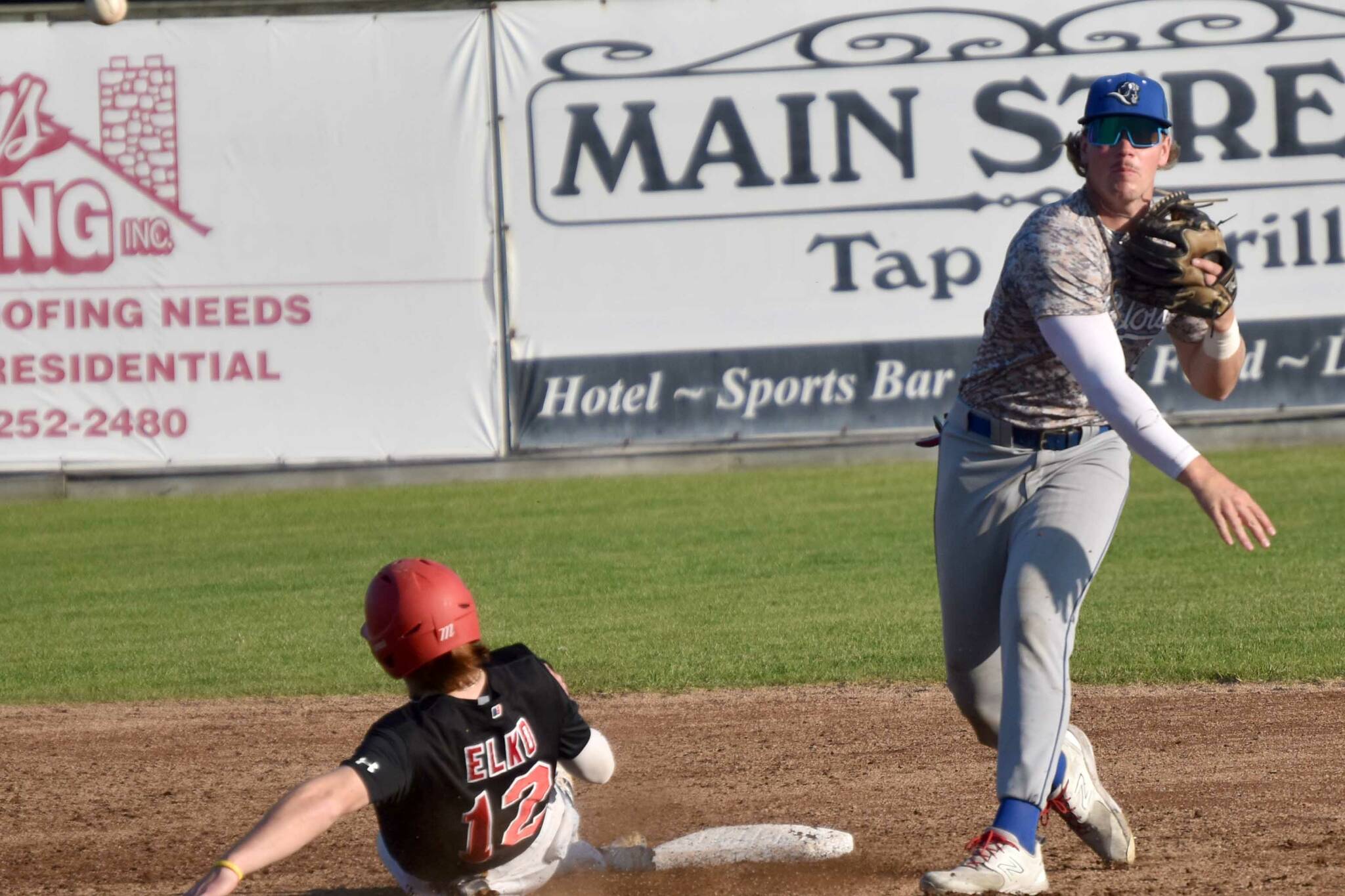 Shaun Montoya of the Anchorage Glacier Pilots turns a double play in front of Michael Elko of the Peninsula Oilers on Saturday, July 22, 2023, at Coral Seymour Memorial Park in Kenai, Alaska. (Photo by Jeff Helminiak/Peninsula Clarion)