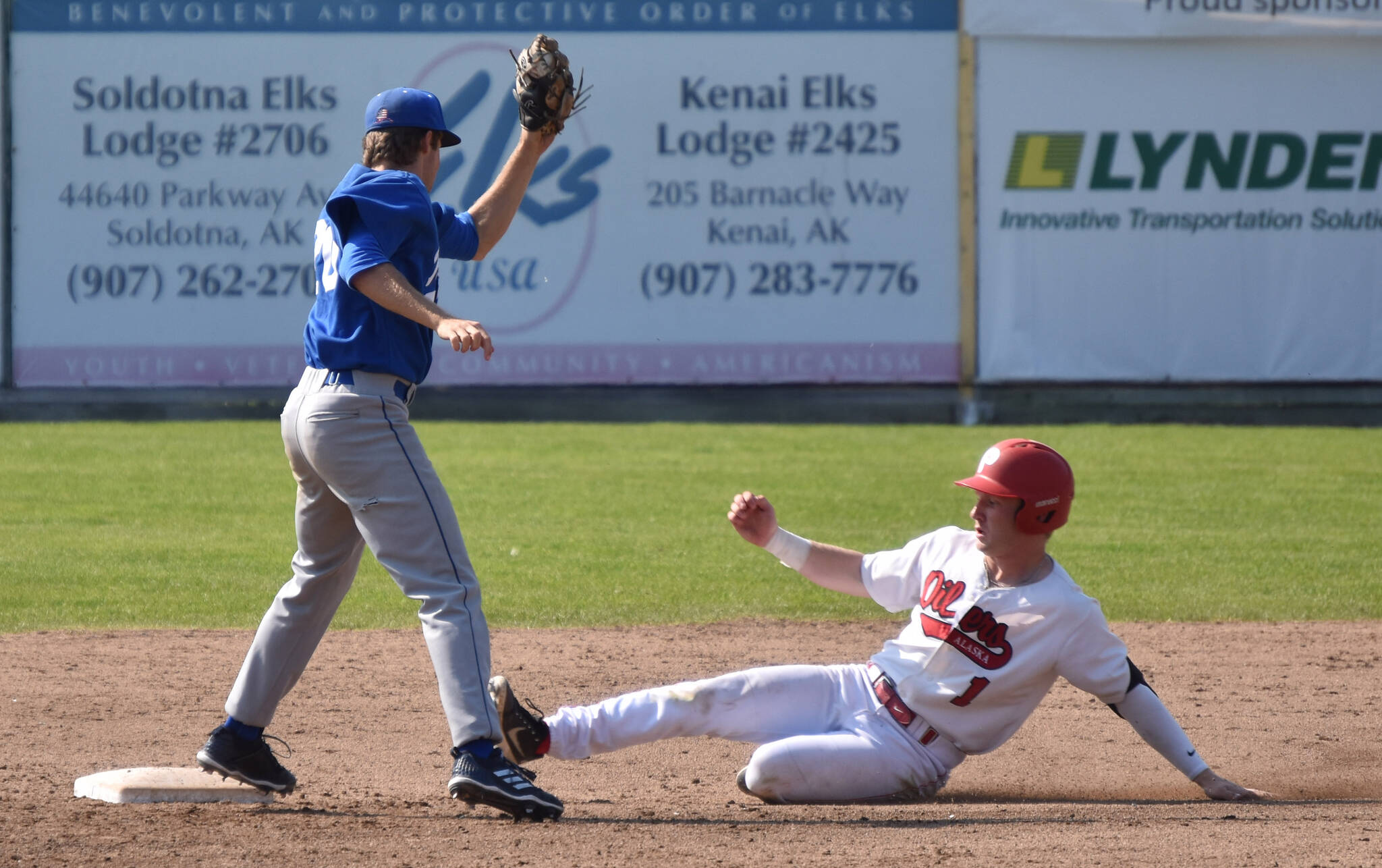 Brett Grupe of the Peninsula Oilers slides under the tag of Anchorage Glacier Pilots shortstop Joey Wright to steal second base Sunday, July 23, 2023, at Coral Seymour Memorial Park in Kenai, Alaska. (Photo by Jeff Helminiak/Peninsula Clarion)