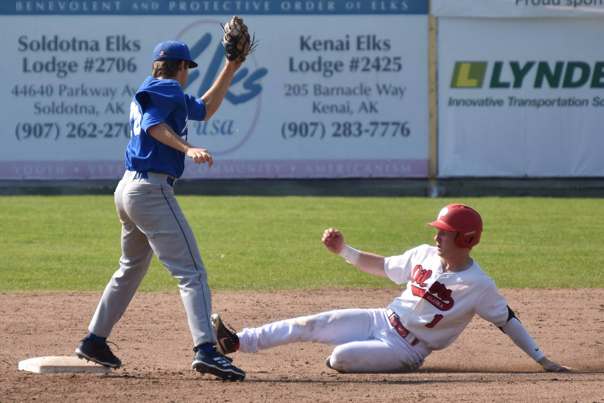 Brett Grupe of the Peninsula Oilers slides under the tag of Anchorage Glacier Pilots shortstop Joey Wright to steal second base Sunday, July 23, 2023, at Coral Seymour Memorial Park in Kenai, Alaska. (Photo by Jeff Helminiak/Peninsula Clarion)