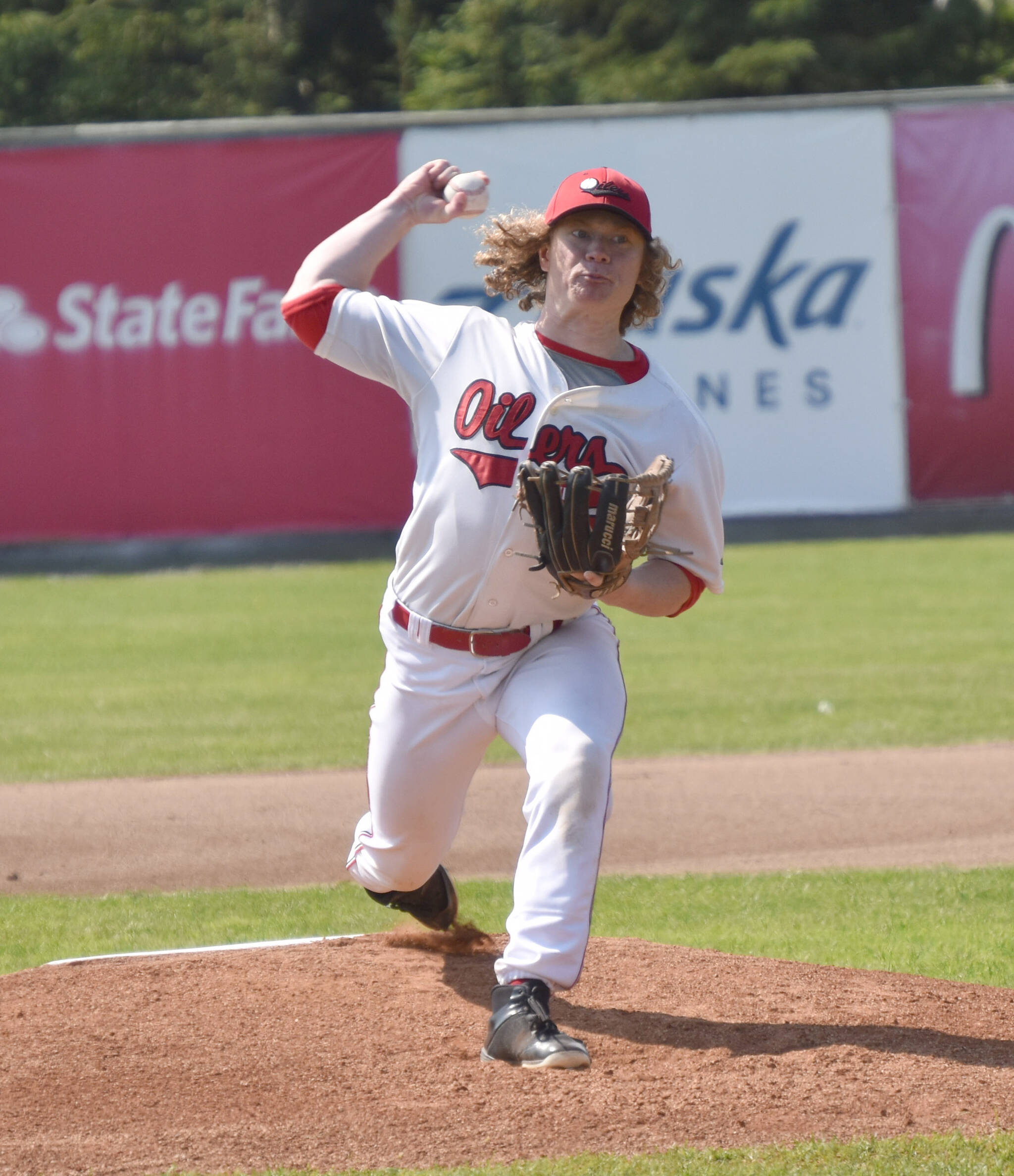 Mose Hayes of the Peninsula Oilers delivers to the Anchorage Glacier Pilots on Sunday, July 23, 2023, at Coral Seymour Memorial Park in Kenai, Alaska. (Photo by Jeff Helminiak/Peninsula Clarion)