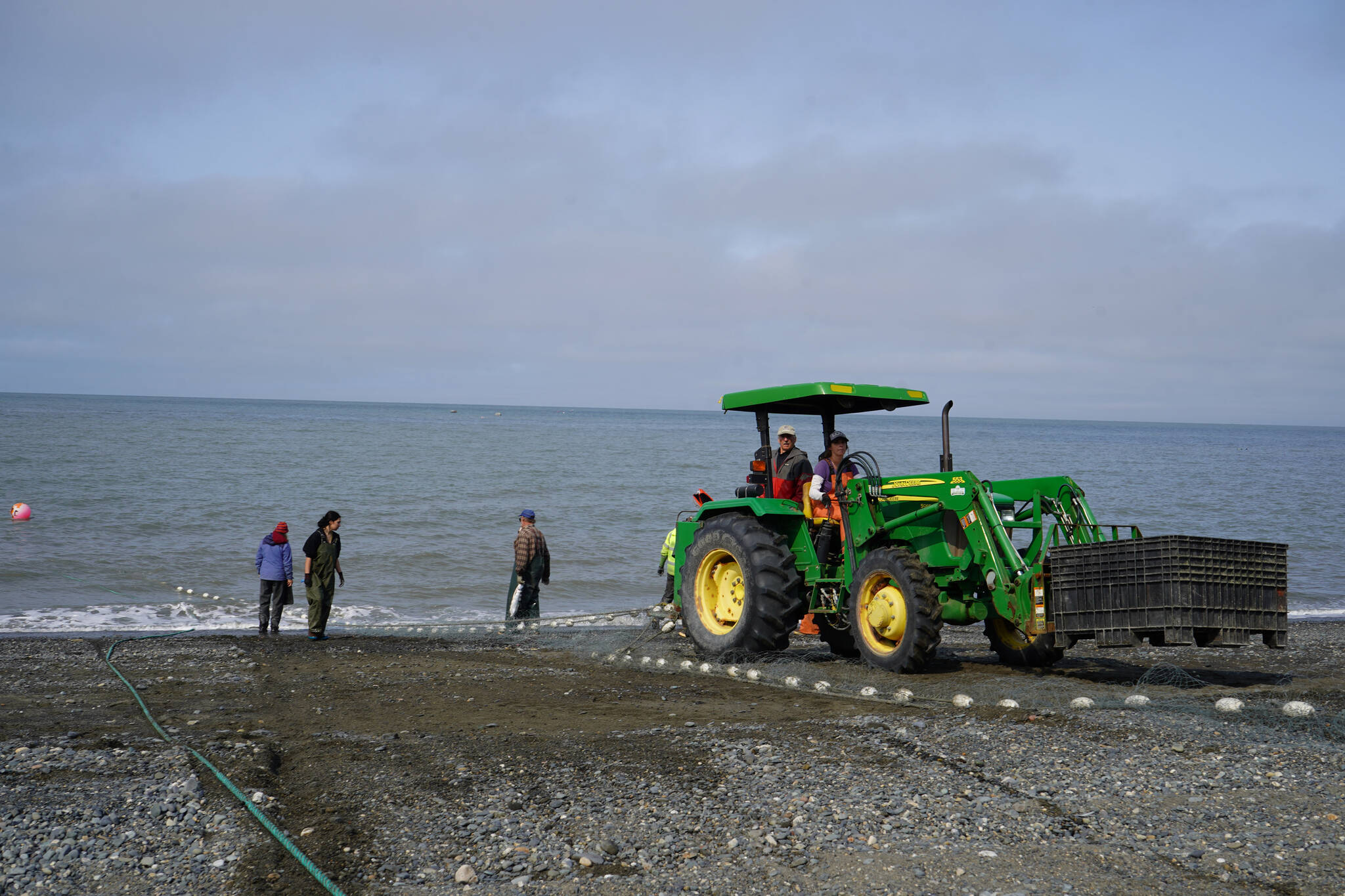 Carrie Hollier uses a tractor to pull in a set gillnet at a test site for selective harvest setnet gear in Kenai, Alaska, on Tuesday, July 25, 2023. (Jake Dye/Peninsula Clarion)