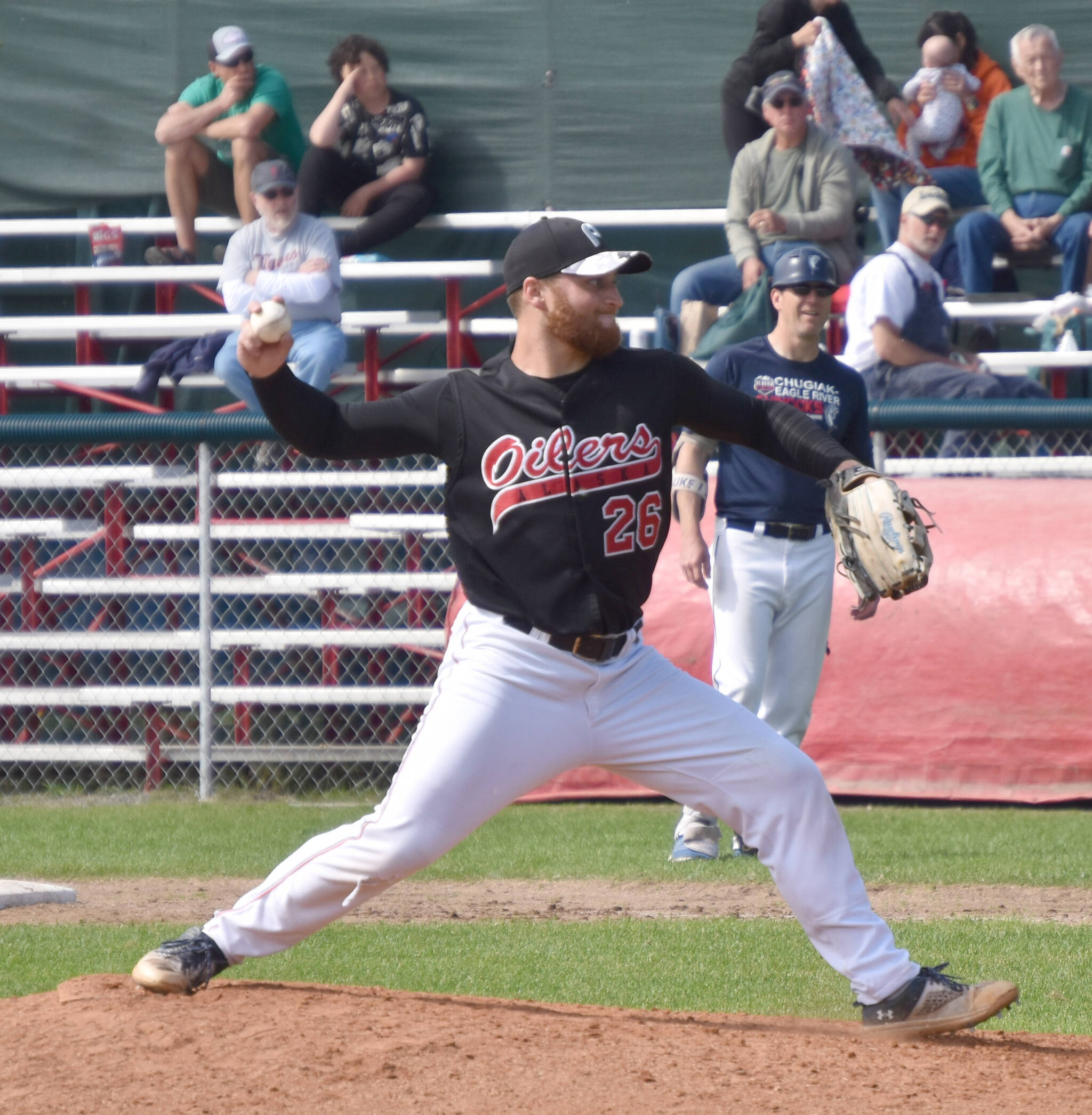 Nick Costello of the Peninsula Oilers, normally a left-hander, pitches right-handed against the Chugiak-Eagle River Chinooks on Sunday, July 30, 2023, at Coral Seymour Memorial Park in Kenai, Alaska. (Photo by Jeff Helminiak/Peninsula Clarion)