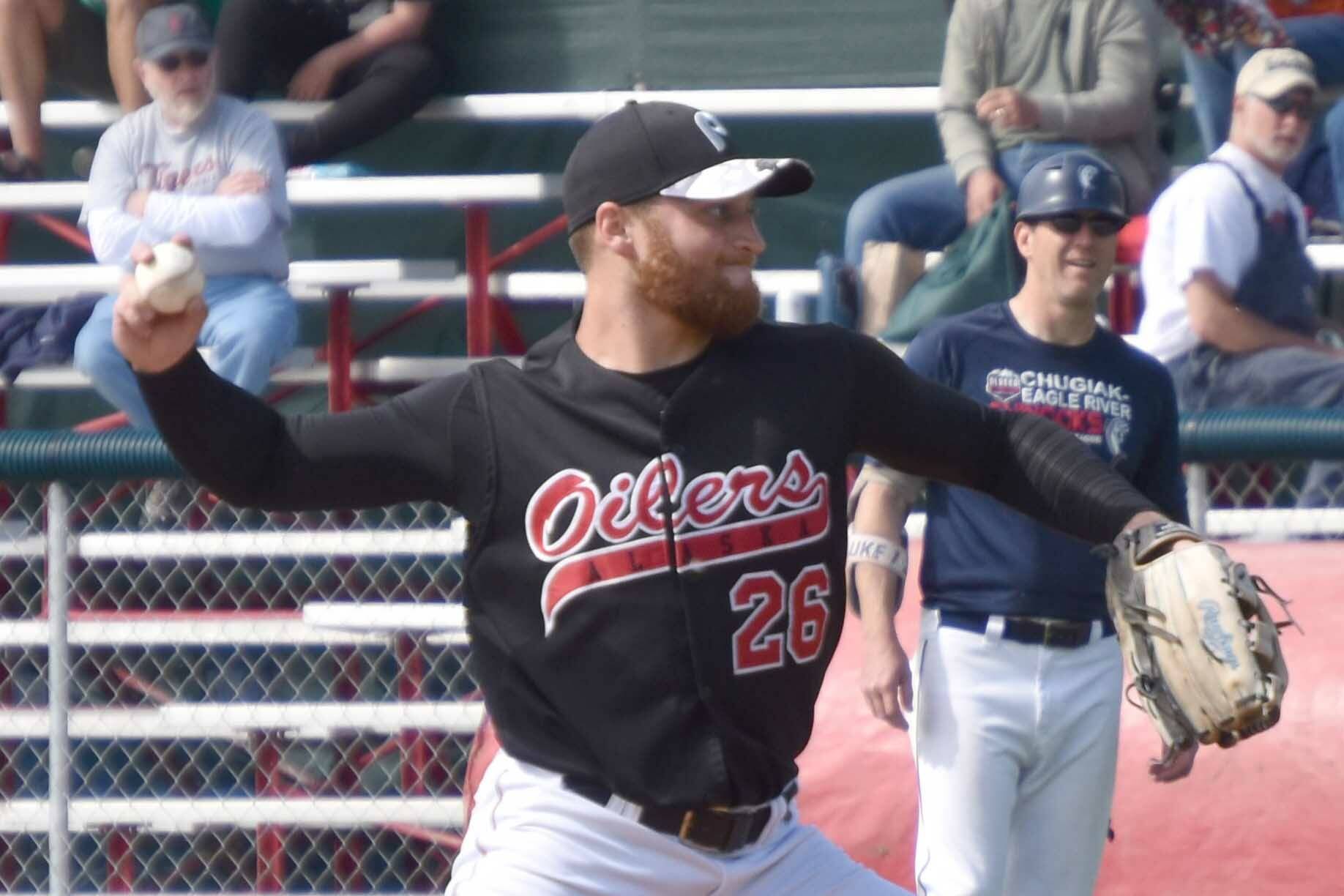 Nick Costello of the Peninsula Oilers, normally a left-hander, pitches right-handed against the Chugiak-Eagle River Chinooks on Sunday, July 30, 2023, at Coral Seymour Memorial Park in Kenai, Alaska. (Photo by Jeff Helminiak/Peninsula Clarion)