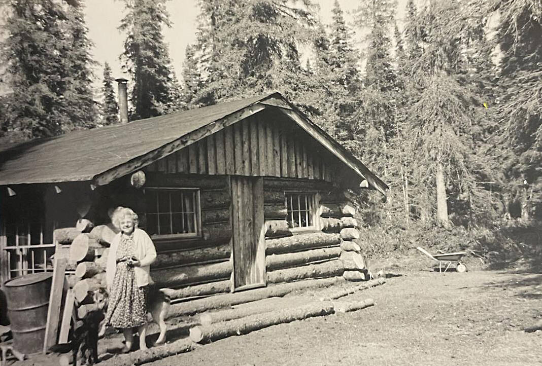 Amanda Walker, of Kenai, poses in front of her friend Mable Smith’s homestead cabin off Kalifornsky Beach Road, circa 1961. (photo courtesy of the Smith Family Collection)