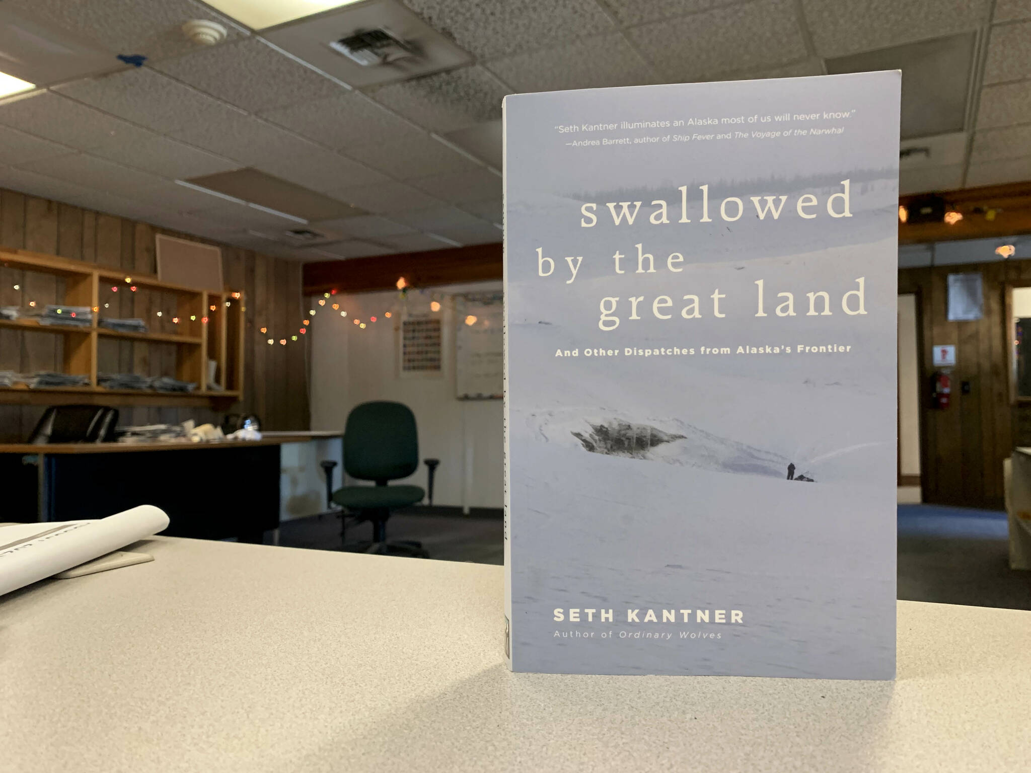 A copy of “Swallowed by the Great Land” sits on a desk in the Peninsula Clarion offices on Thursday, Aug. 3, 2023, in Kenai, Alaska. (Ashlyn O’Hara/Peninsula Clarion)