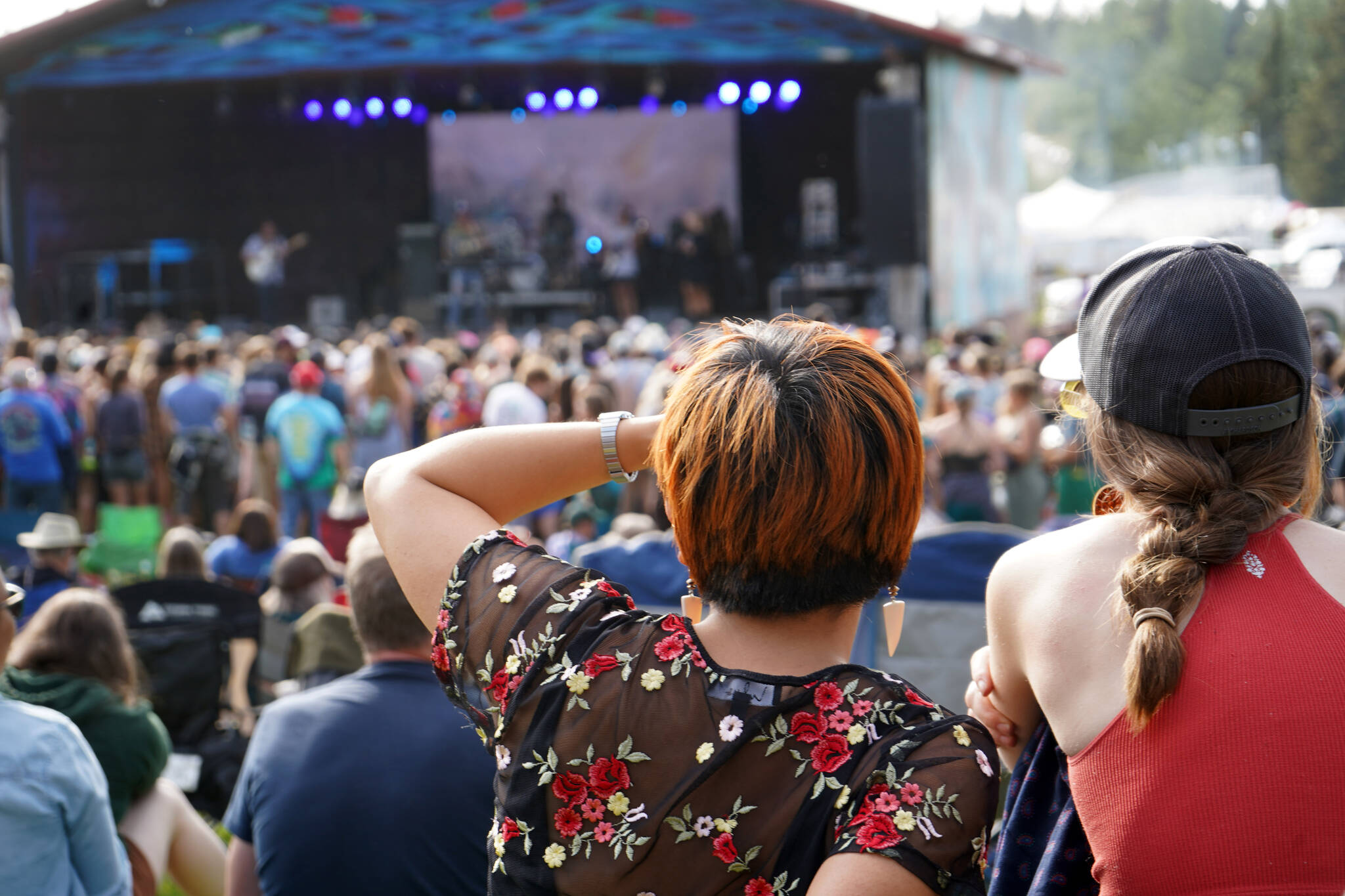 Attendees view a performance by Medium Build on the River Stage at Salmonfest in Ninilchik, Alaska, on Friday, Aug. 4, 2023. (Jake Dye/Peninsula Clarion)