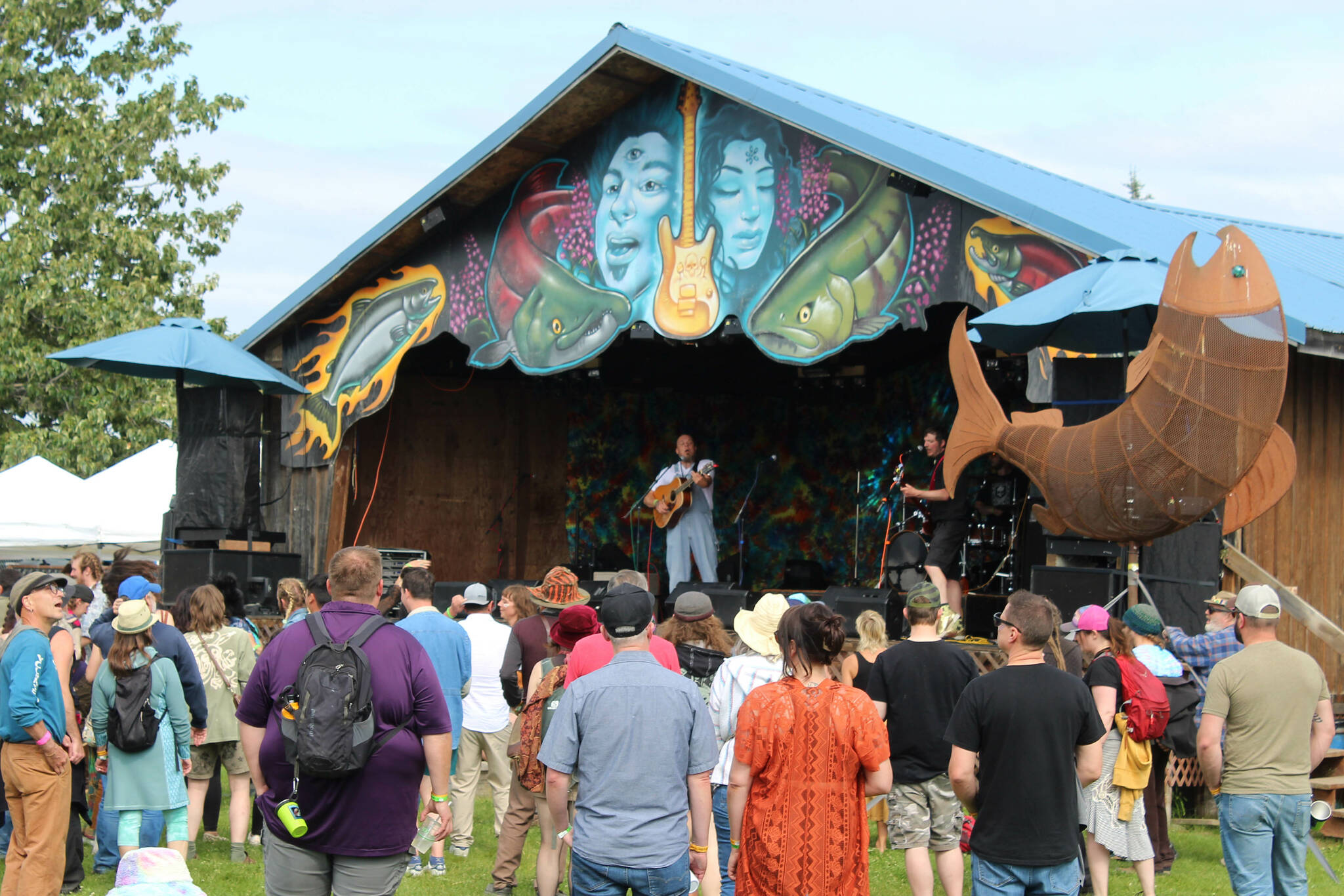 People listen to the Discopians perform at the Salmonfest Ocean Stage on Friday, Aug. 4, 2023 in Ninilchik, Alaska. (Ashlyn O'Hara/Peninsula Clarion)
