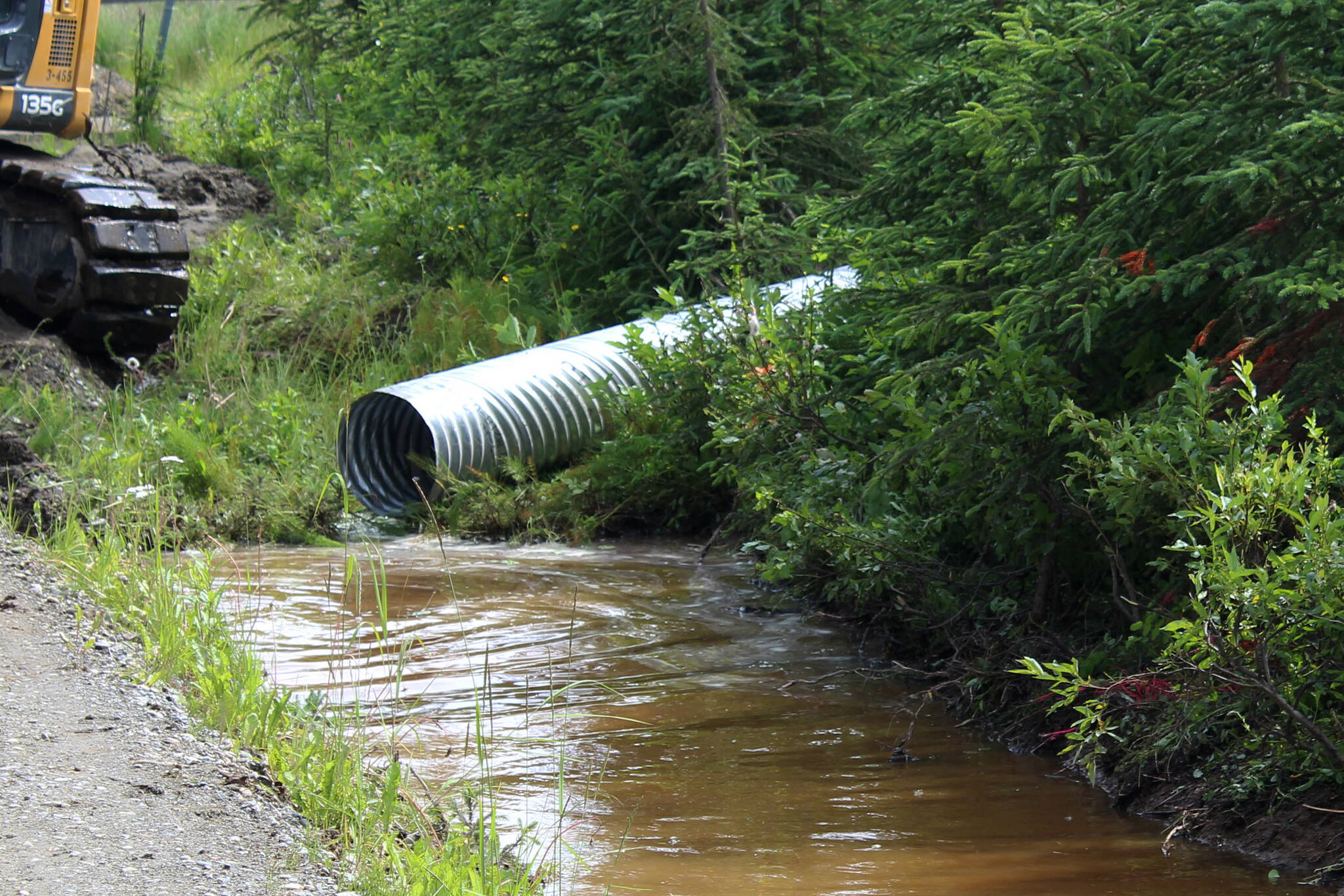 Water pools near at the intersection of Patrick Drive and Bjerke Street, where contractors for the Kenai Peninsula Borough install a culvert to mitigate flooding off of Kalifornsky Beach Road on Friday, July 21, 2023 near Kenai, Alaska. (Ashlyn O’Hara/Peninsula Clarion) ,