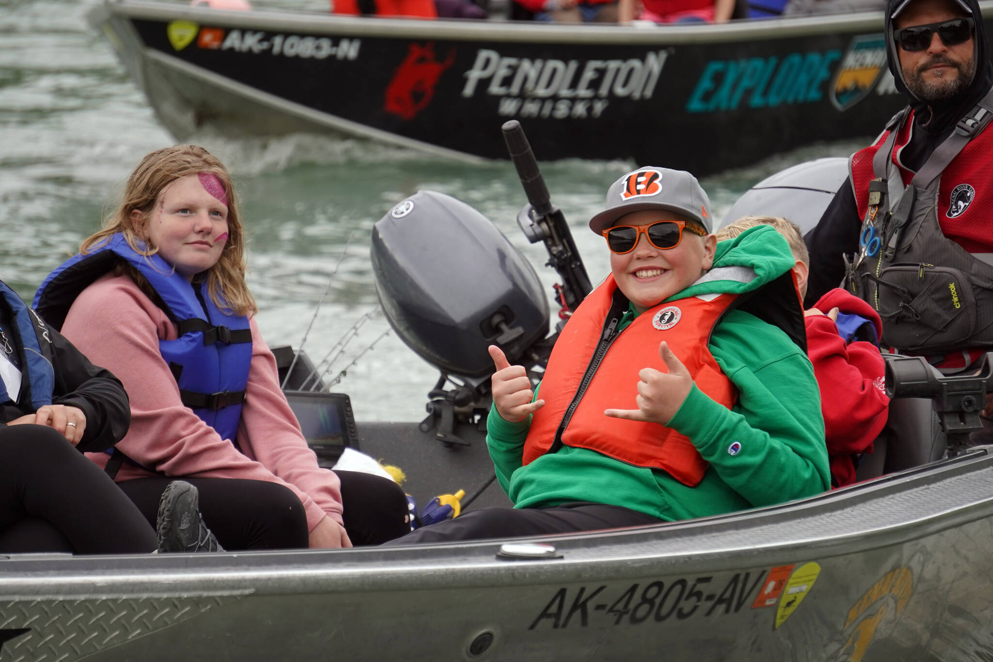 Boats with kids, guides, and freshly caught salmon return to shore at the Kenai River Junior Classic in Soldotna, Alaska, on Wednesday, Aug. 9, 2023. (Jake Dye/Peninsula Clarion)