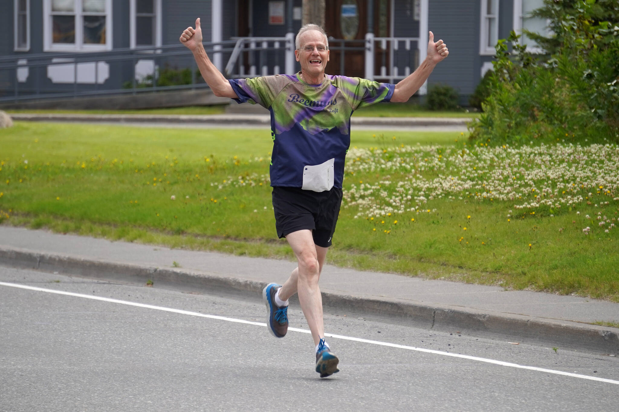 Jim White races toward the finish chute of the 34th Annual Kenai Peninsula Violence Free Community Run in Kenai, Alaska, on Saturday, Aug. 12, 2023. (Jake Dye/Peninsula Clarion)