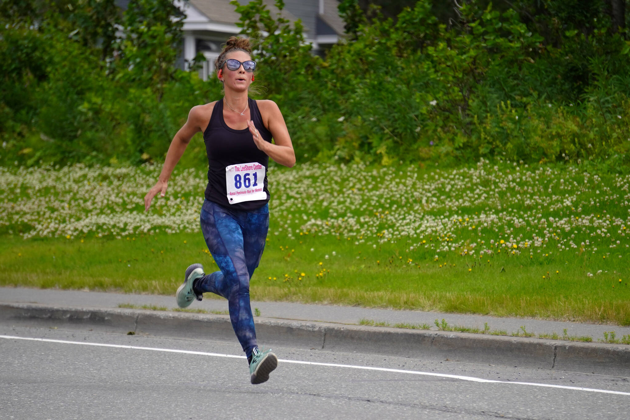 Shari BeDunnah, first place finisher for the Women’s 5K, races towards the finish chute of the 34th Annual Kenai Peninsula Violence Free Community Run in Kenai, Alaska, on Saturday, Aug. 12, 2023. (Jake Dye/Peninsula Clarion)