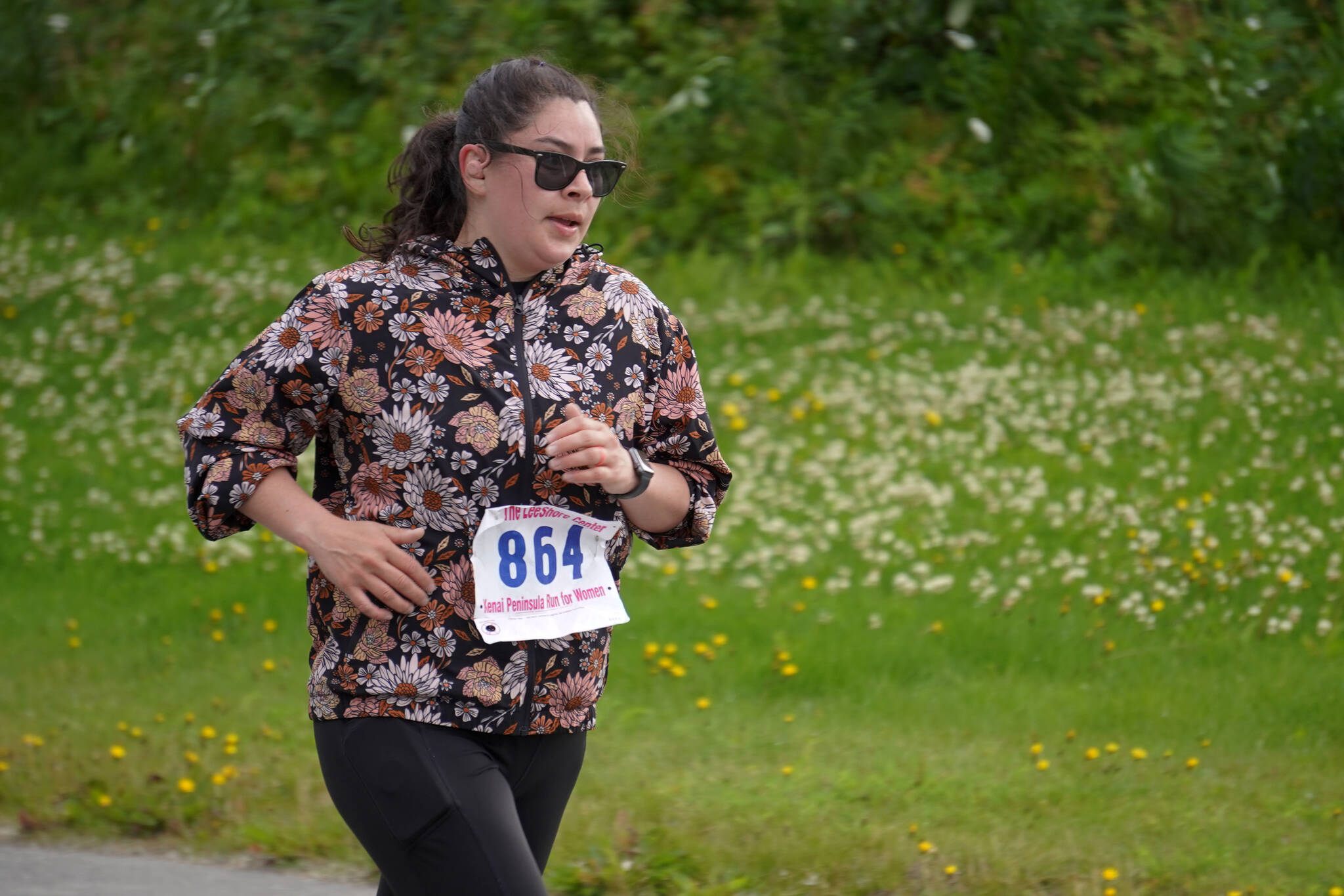 Stephanie Macias races toward the finish chute of the 34th Annual Kenai Peninsula Violence Free Community Run in Kenai, Alaska, on Saturday, Aug. 12, 2023. (Jake Dye/Peninsula Clarion)