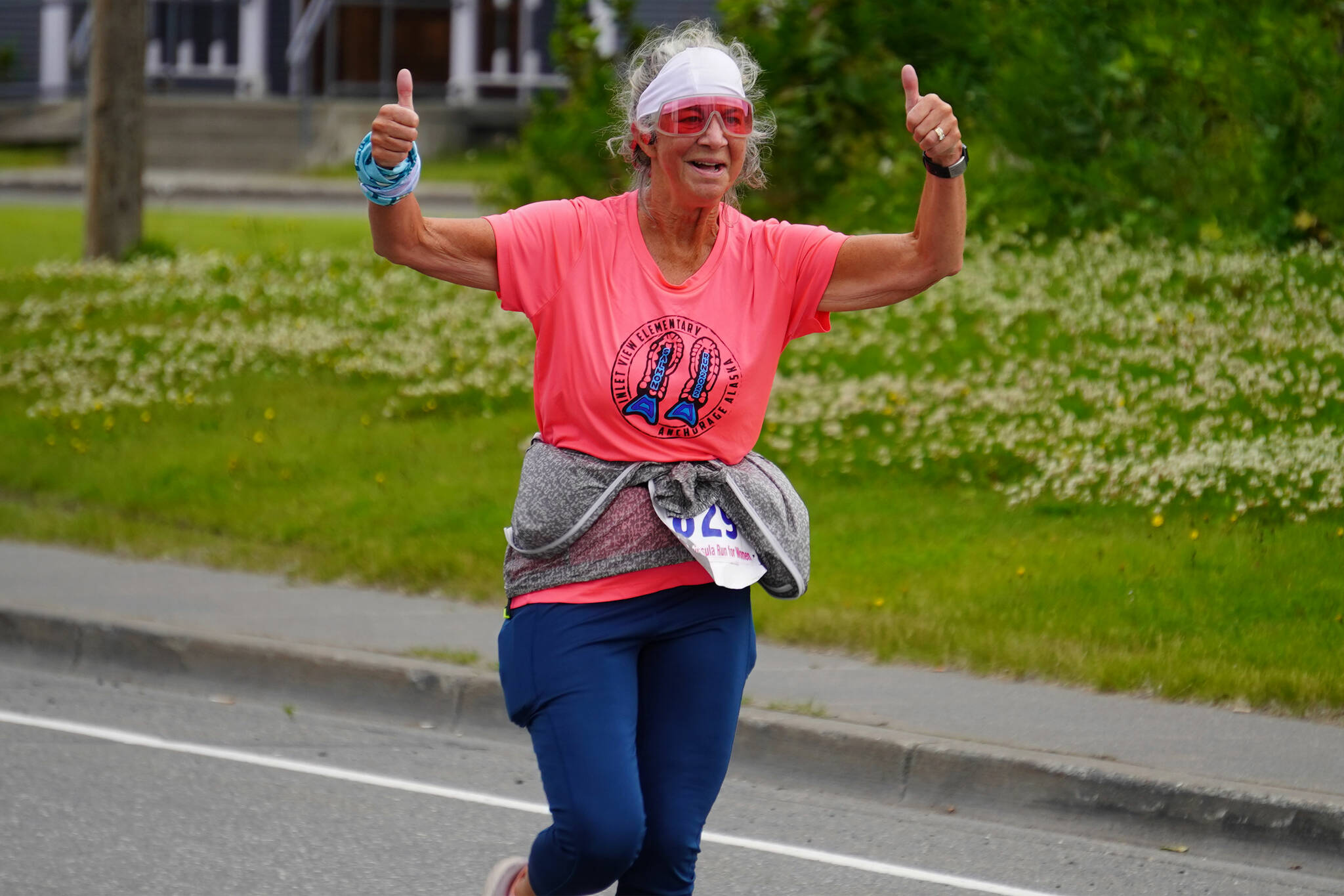 Renee Helie races towards the finish chute of the 34th Annual Kenai Peninsula Violence Free Community Run in Kenai, Alaska, on Saturday, Aug. 12, 2023. (Jake Dye/Peninsula Clarion)