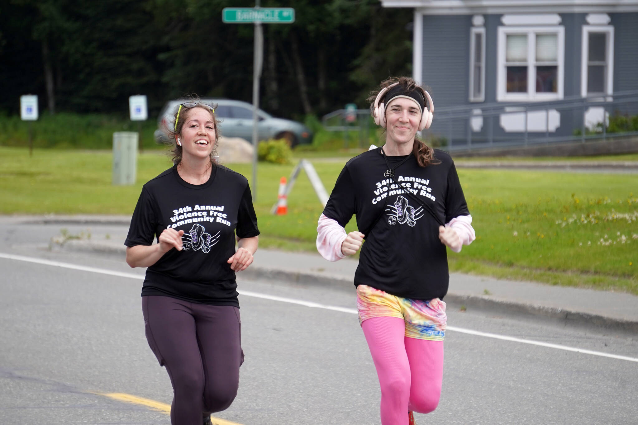 Meghan Thibodeau and Didi Peters race to the finish chute of the 34th Annual Kenai Peninsula Violence Free Community Run in Kenai, Alaska, on Saturday, Aug. 12, 2023. (Jake Dye/Peninsula Clarion)