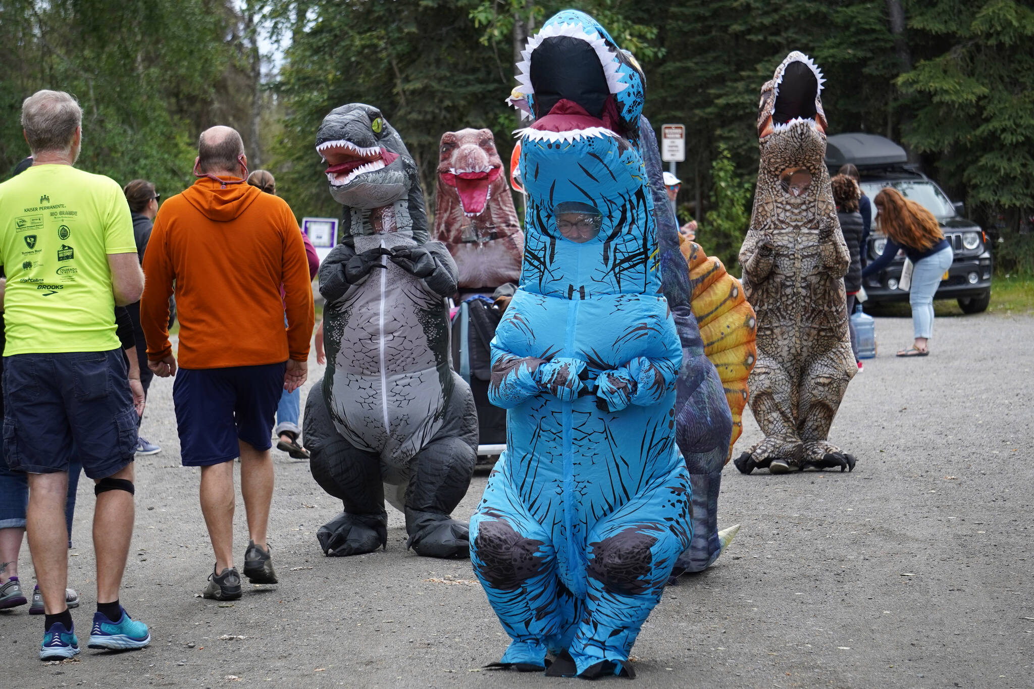 The Dino Divas participate in the Brewery to Bathroom .5K at Soldotna Creek Park in Soldotna, Alaska, on Sunday, Aug. 13, 2023. (Jake Dye/Peninsula Clarion)