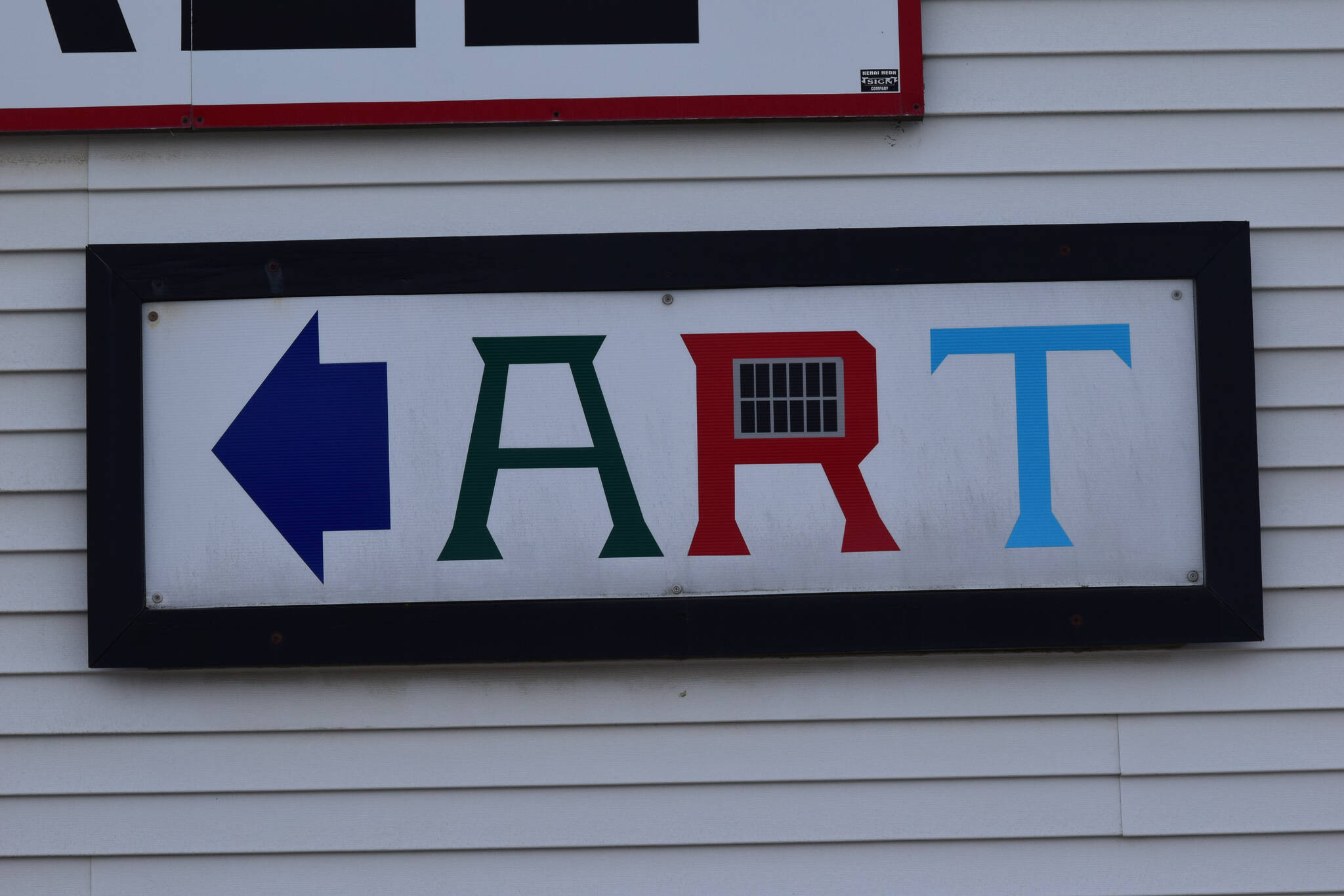 A sign points to the Kenai Art Center on Sunday, May 9, 2021. (Camille Botello / Peninsula Clarion)